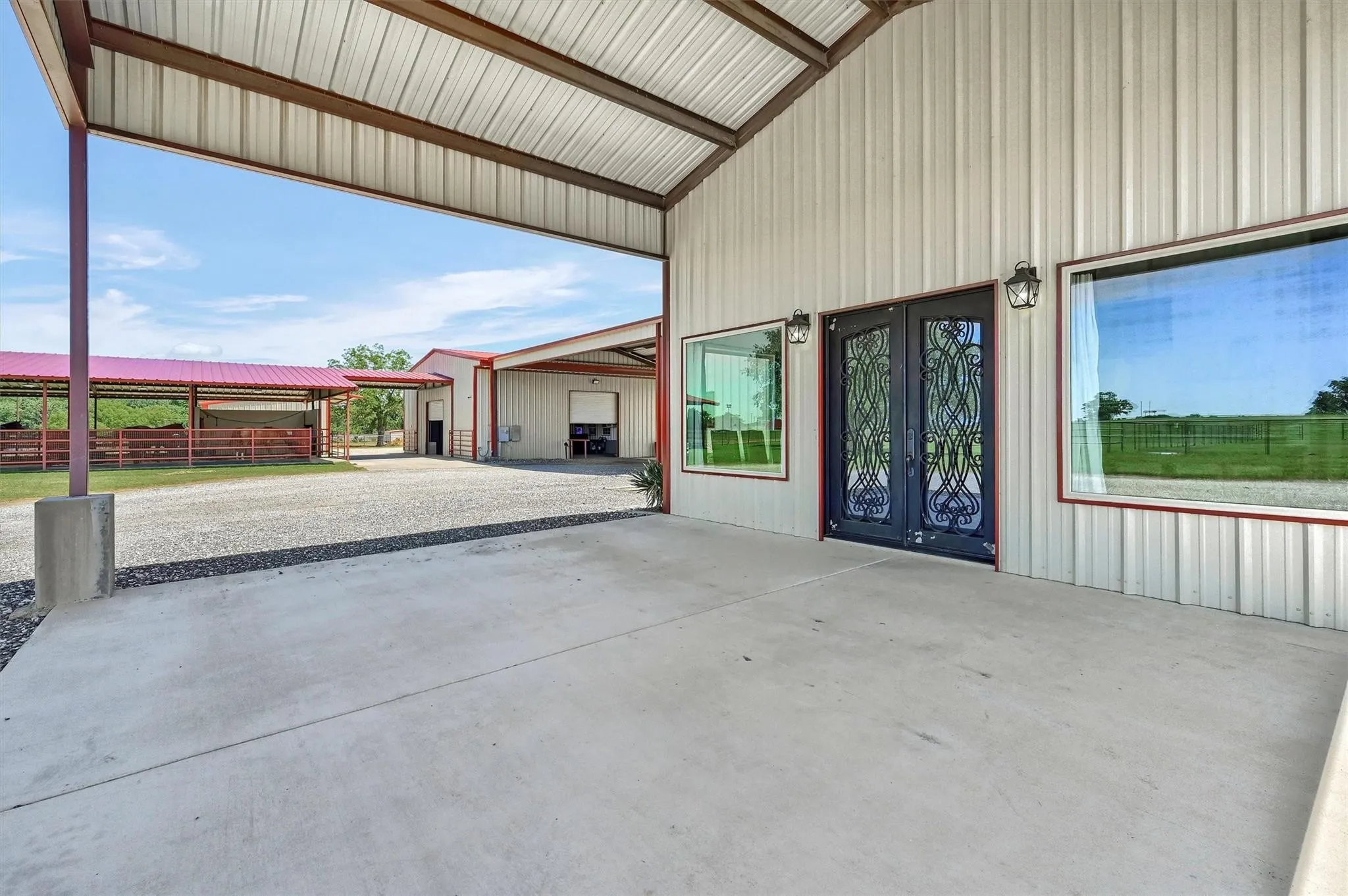 Covered front porch and entrance to visitors lounge.  Mare motel across driveway to the north.