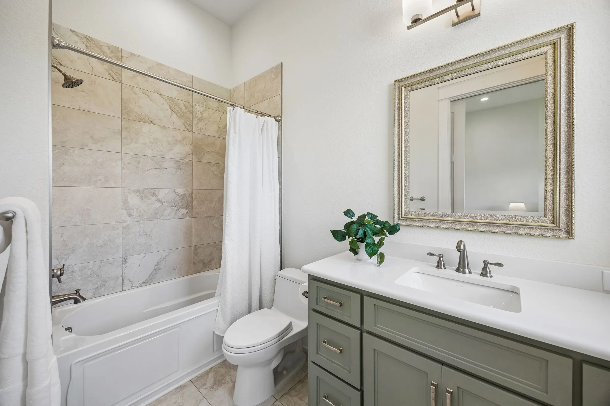 Ensuite bathroom with stunning cabinetry and quartz countertops.
