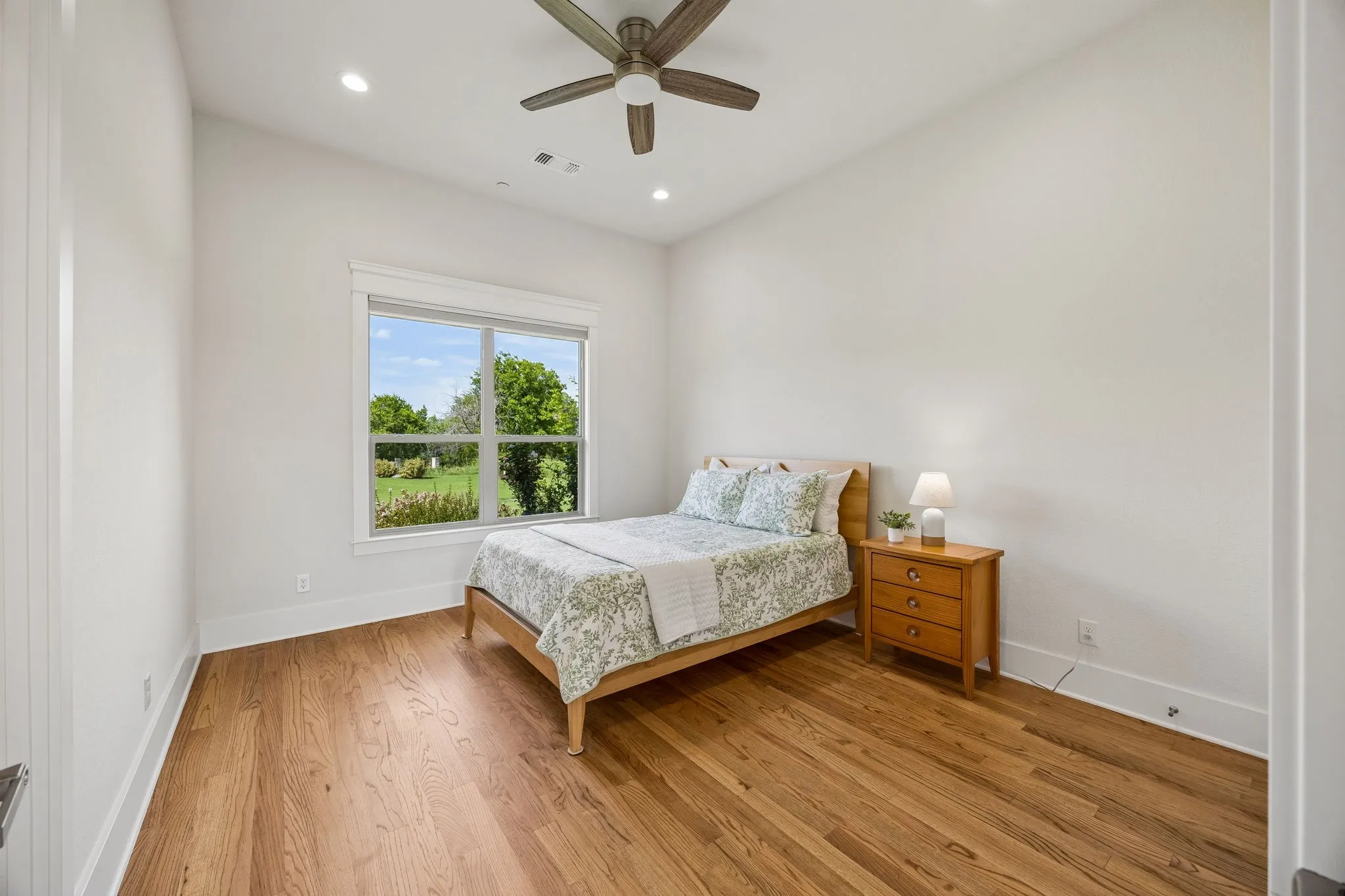 Secondary bedroom with soaring ceilings, custom closet, and ensuite bath.