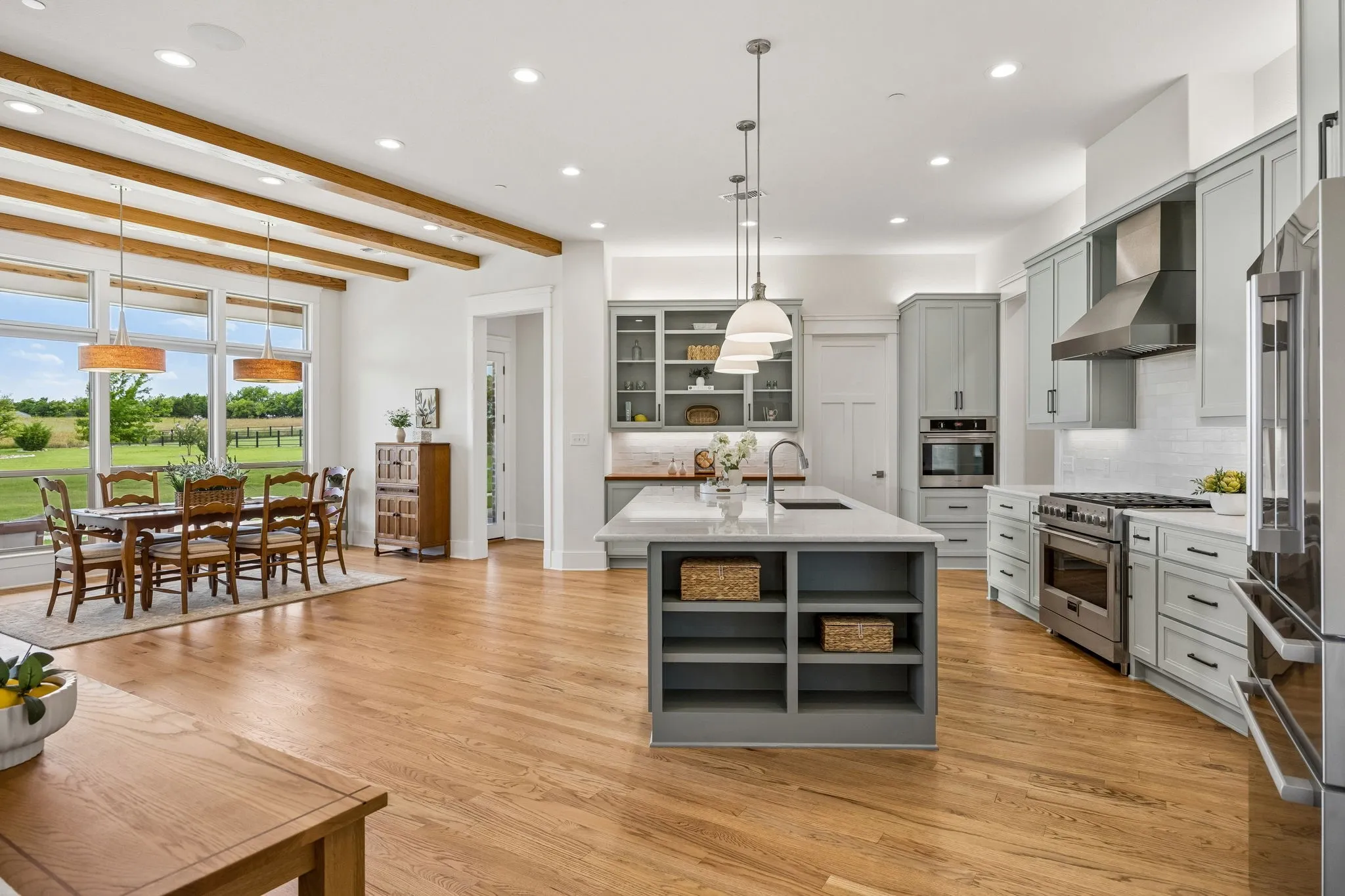 Soaring 11 to 14-foot ceilings, gorgeous hardwood floors, Cambria quartz, custom lighting, extensive wood beam detail, and solid core doors throughout.