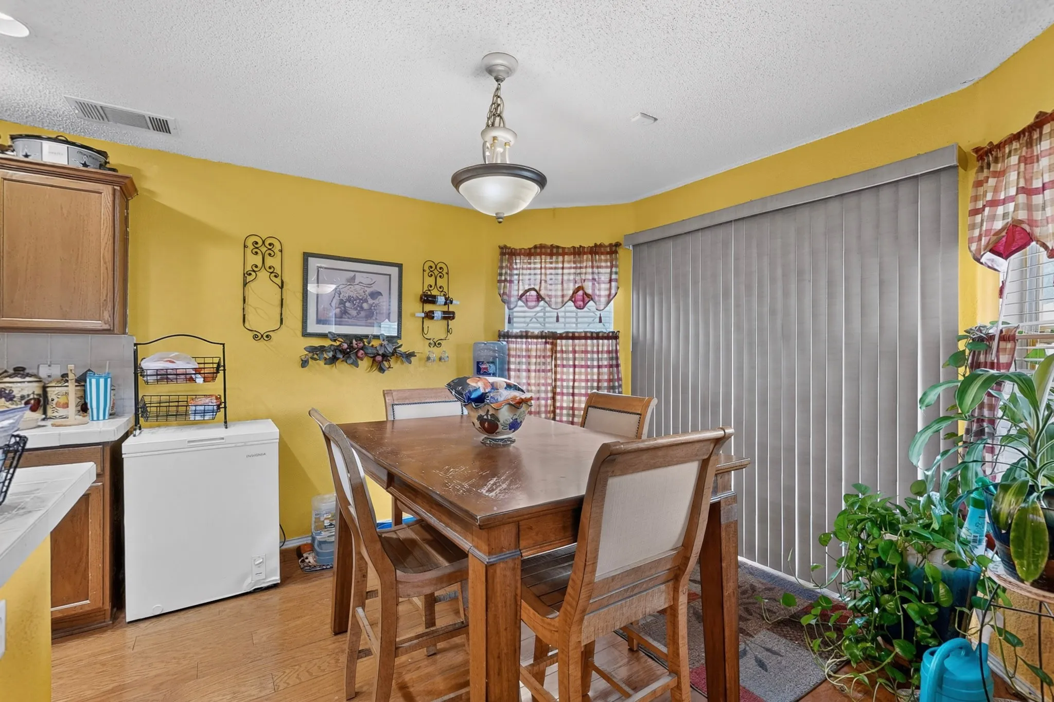 Dining area featuring wood-finish flooring and a ceiling-mounted light fixture