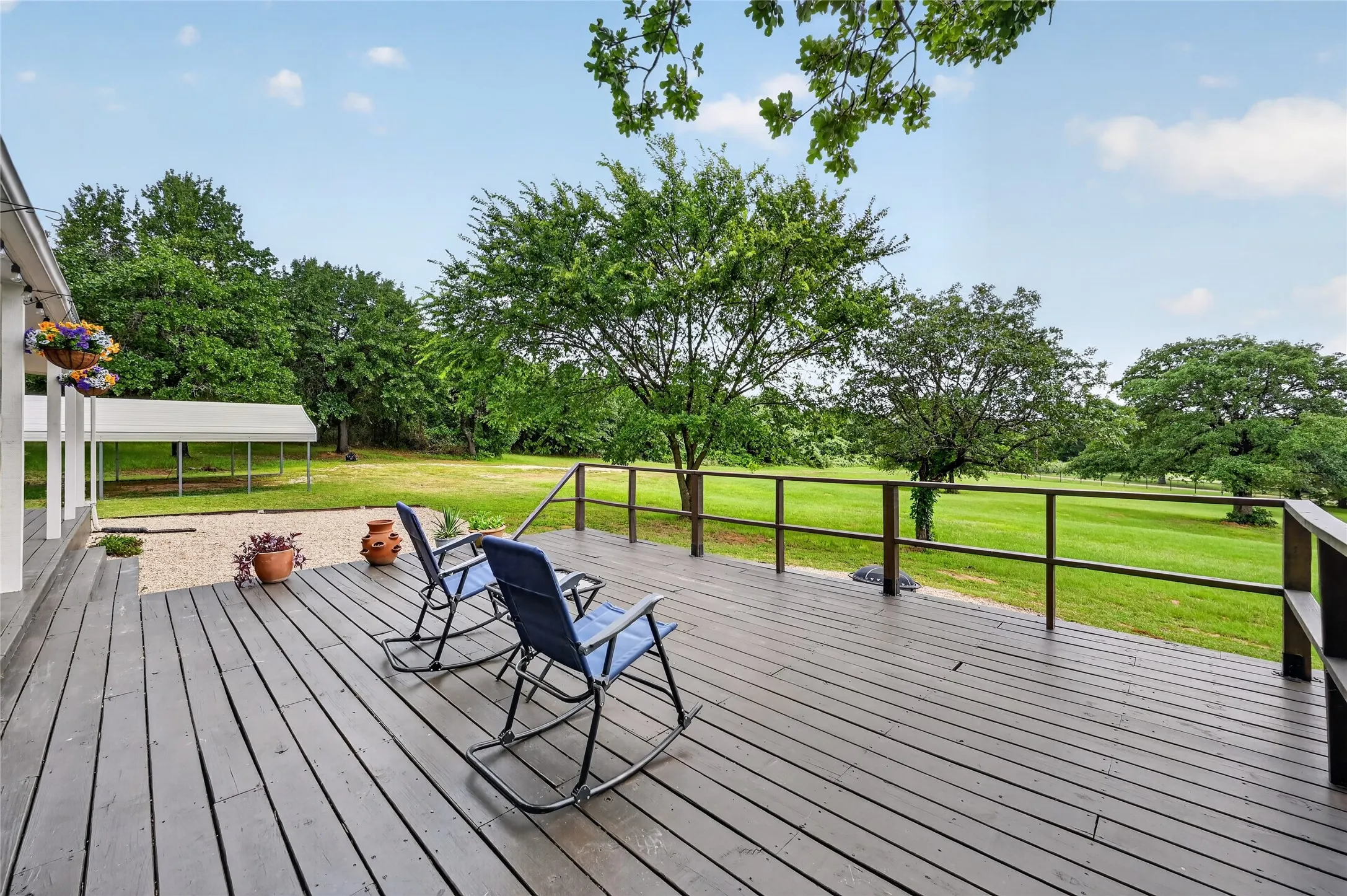 Expansive outdoor deck with dark wood.