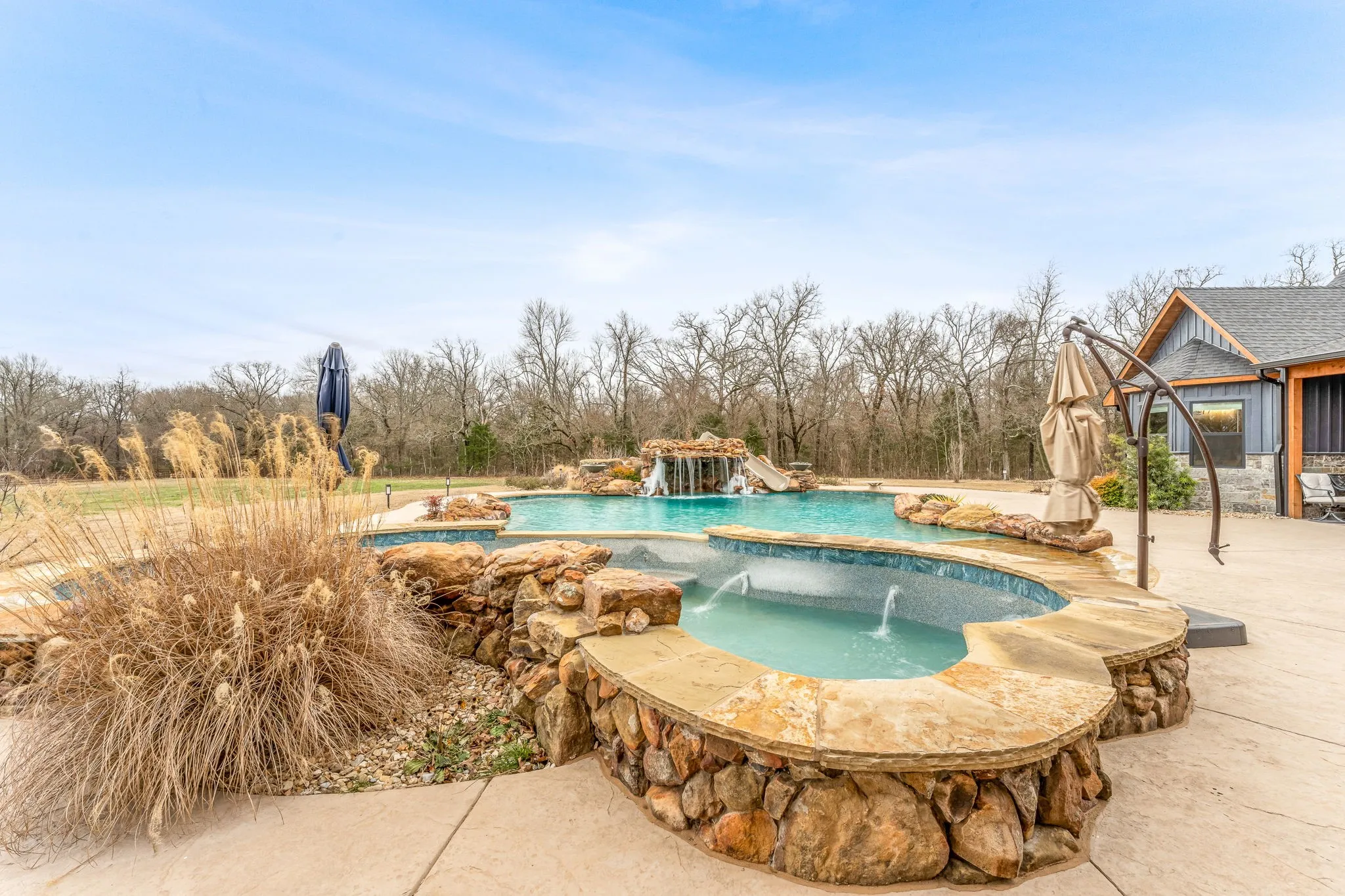 Outdoor pool with a patio and an outdoor hot tub