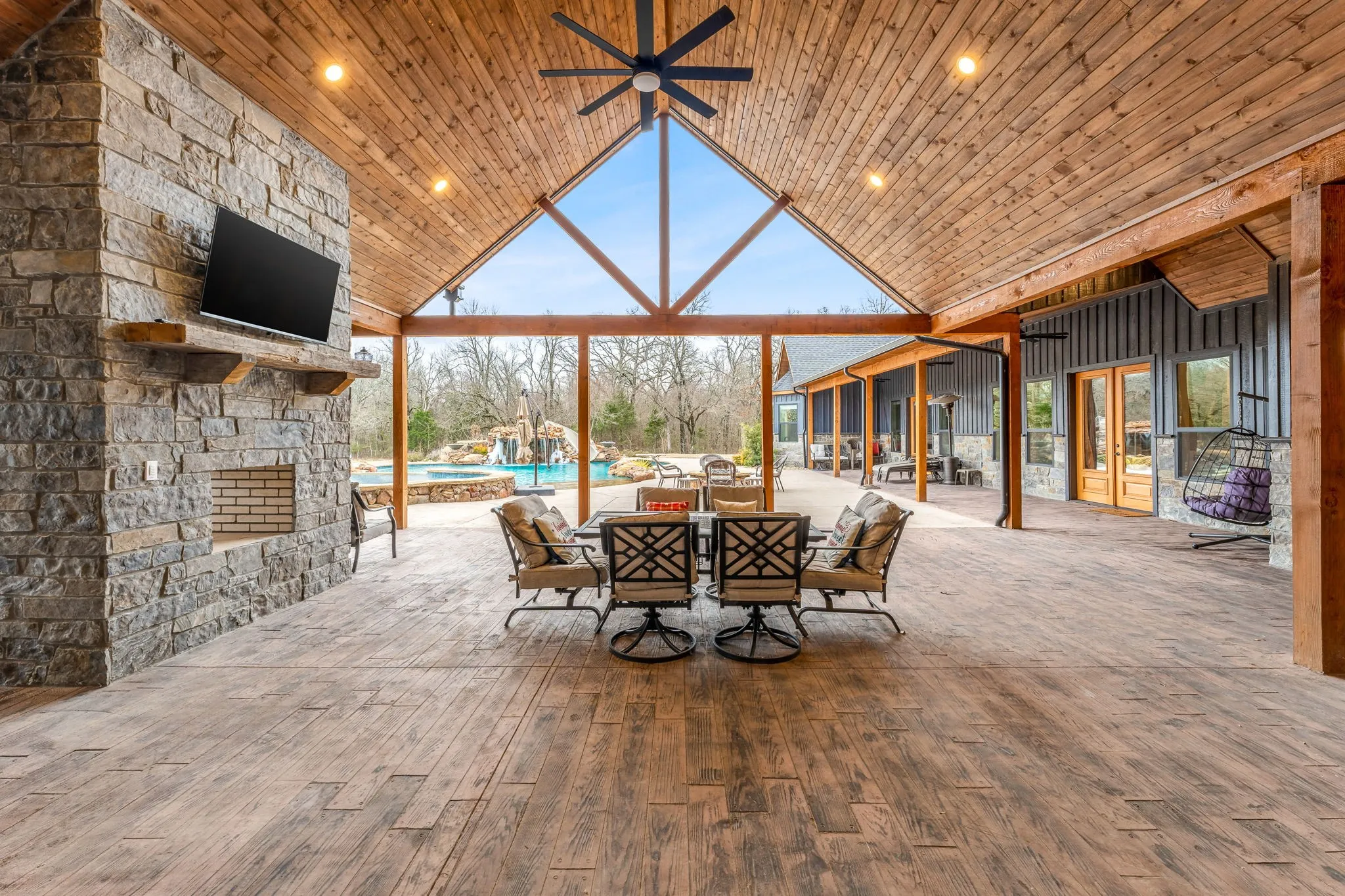 View of patio with a ceiling fan, outdoor dining space, and an outdoor pool