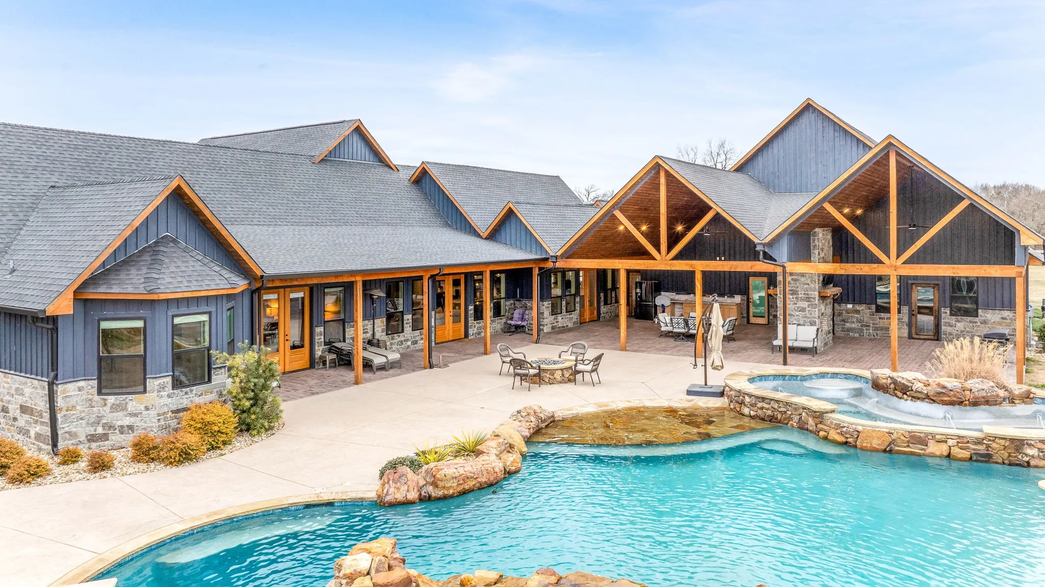 View of pool with a patio and a pool with connected hot tub