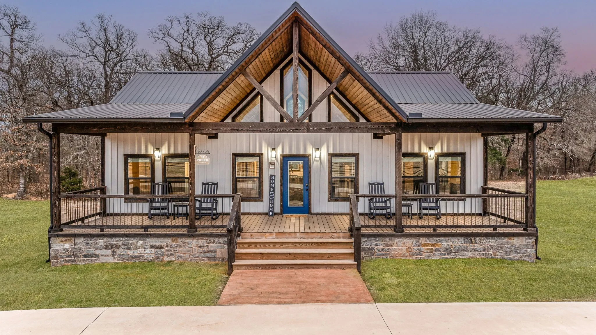 View of front of house featuring covered porch, a metal roof, a front lawn, and board and batten siding