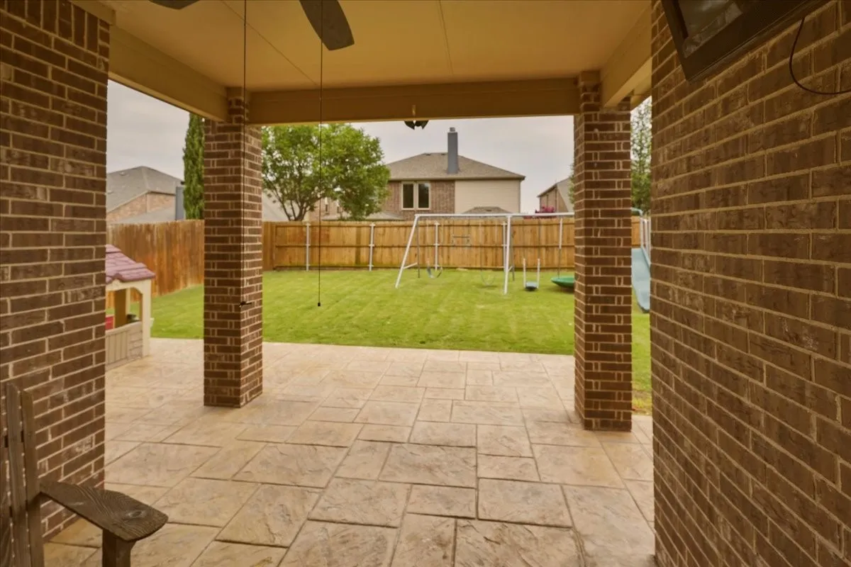 Extended covered patio with stamped concrete.  Outdoor TV stays with property.