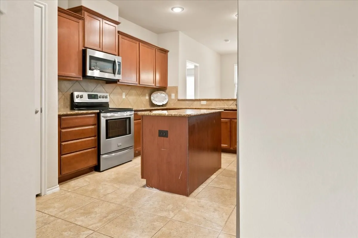 Kitchen with SS appliances.