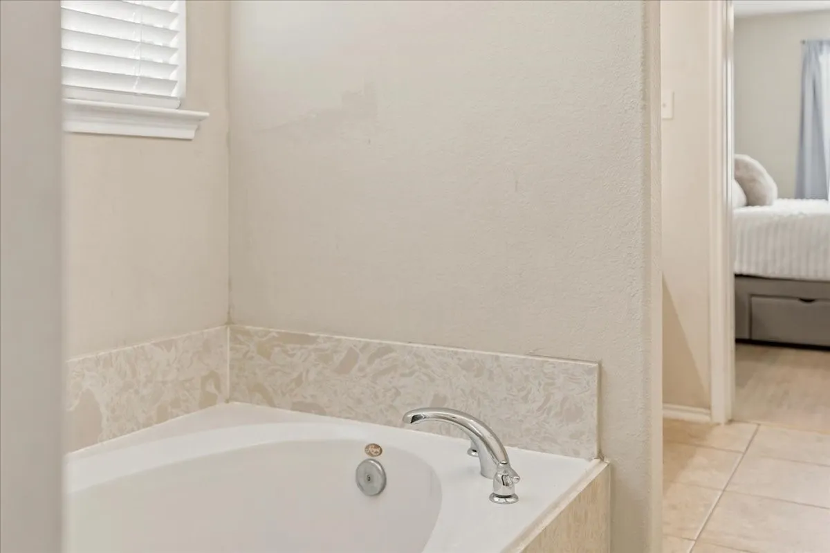 Separate garden tub and shower in primary bath.
