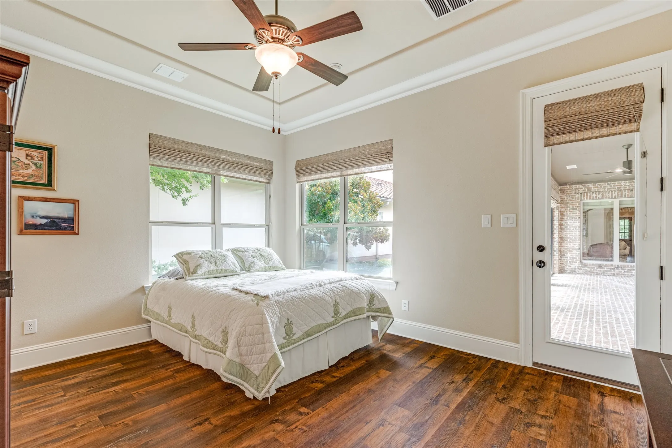 Luxury vinyl plank floors make maintenance easy.  The raised ceiling has crown molding and a ceiling fan with a light.  A group of corner windows view the private back yard, and a door opens to the breezeway that has a direct connection to the main part of the home.  Cold, rainy or hot, the breezeway and casita have their own HVAC system, so no need to weather a storm outside to access this casita!