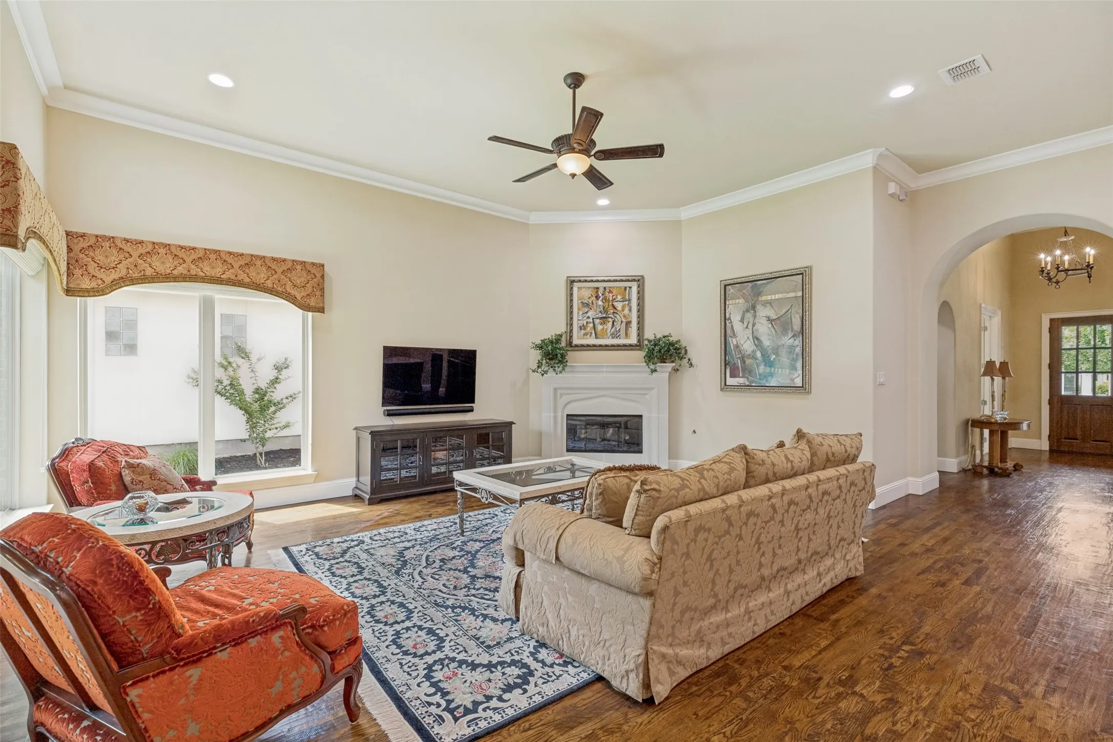Crown moldings adds interest in the family room and a ceiling fan with a light and recessed lights are available.  Owners will find this room to be a comfortable spot to enjoy a cozy fire while they watch their favorite TV series or sports game.  A pair of large corner windows visually open the room to the outside.