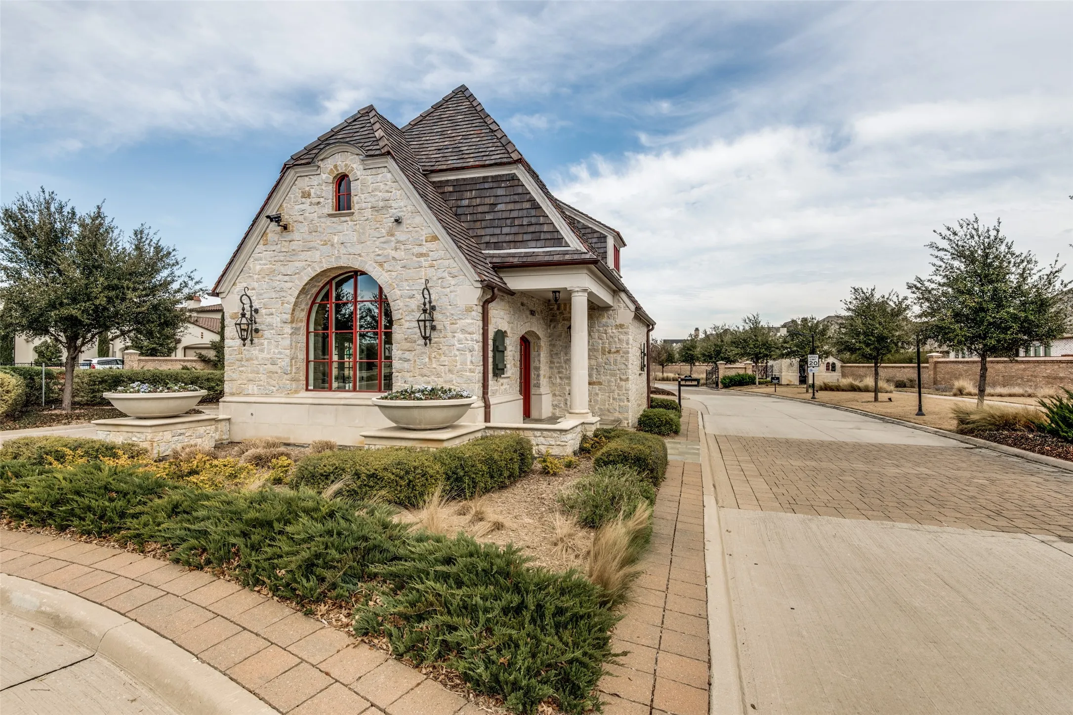 Newman Village is a very popular exclusive up-scale community in Frisco, and guards in this charming guardhouse maintain controlled access to the neighborhood.  Visitors and vendors must be approved for entry.  The HOA dues pays for a 24-hour guard along with all the additional amenities in the community.