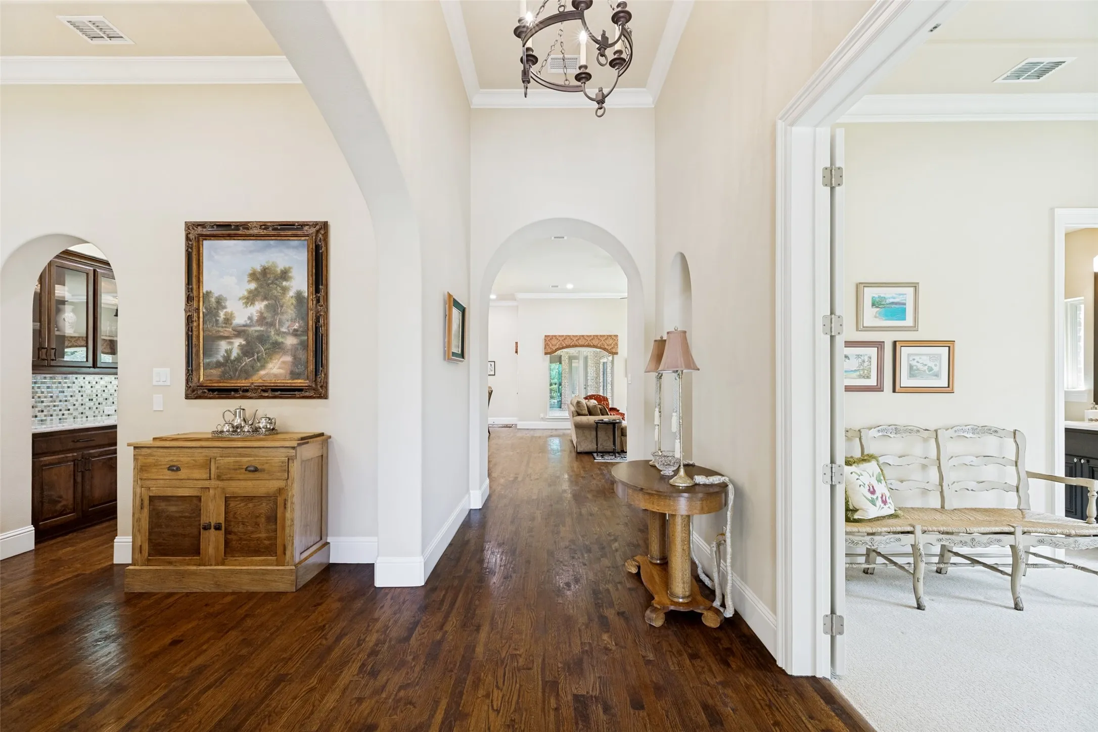From the front door, the gleaming wood floors lead the eye to the family room and outside views beyond.  The extensive crown molding in the home continues in other areas of the home.