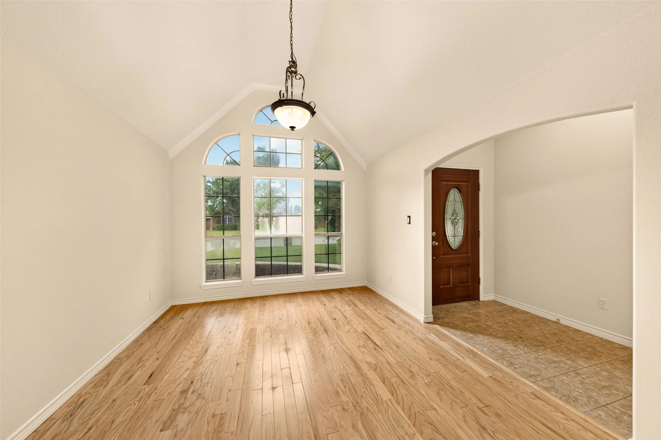 Elegant formal dining room with soaring ceilings and abundant natural light