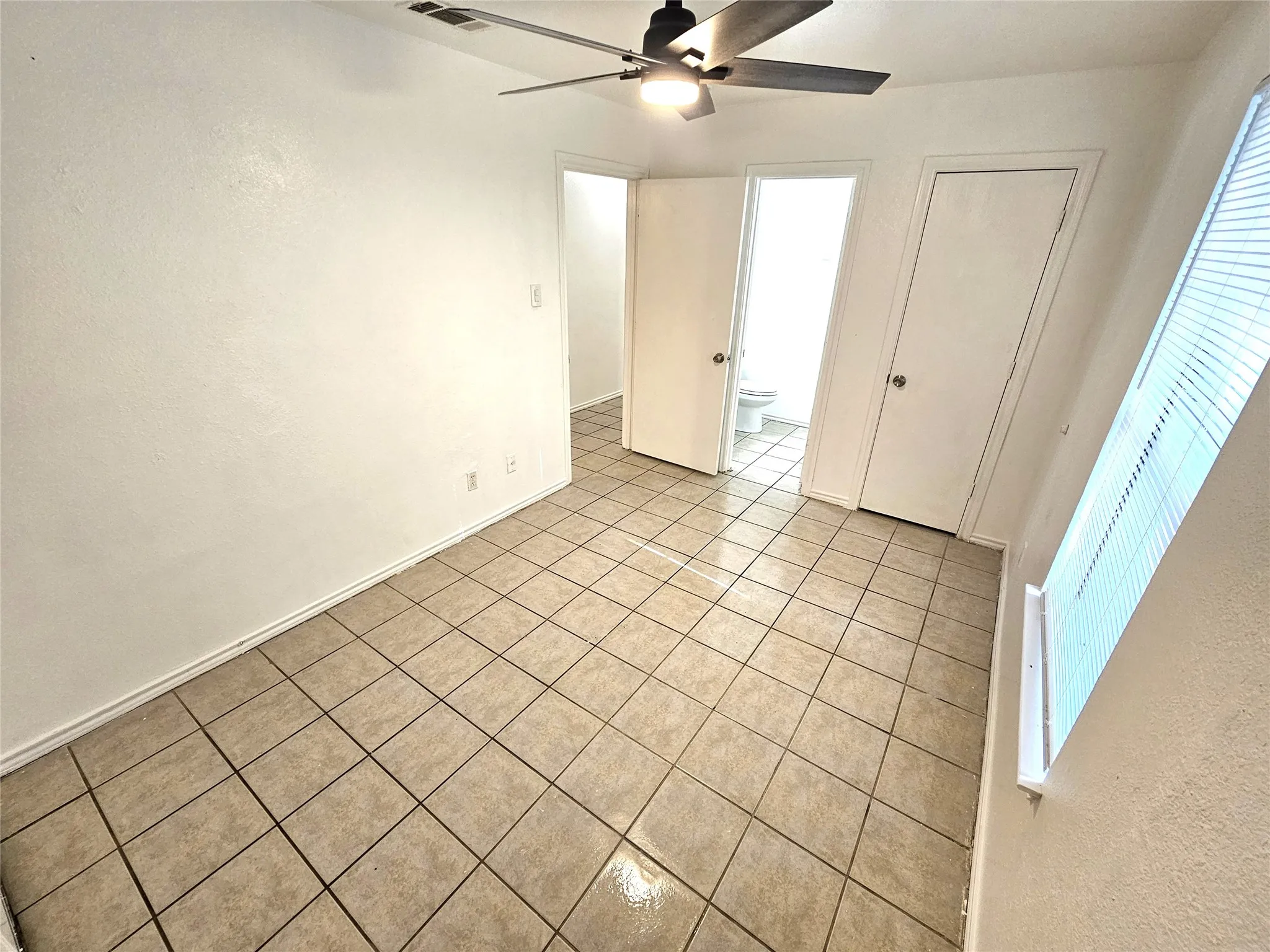Master bedroom with half bath and a door access to private backyard