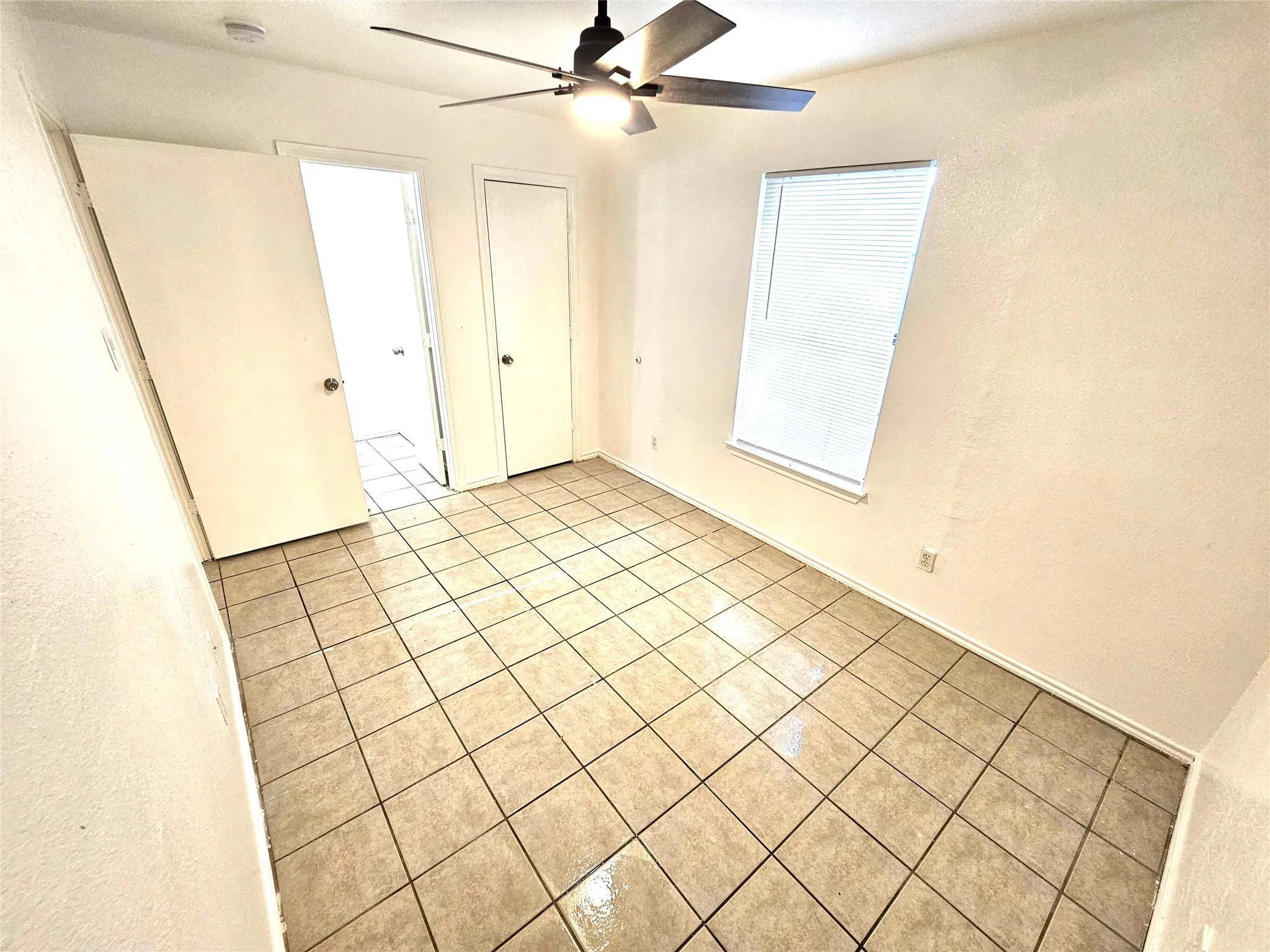 Master bedroom with half bath and a door access to private backyard