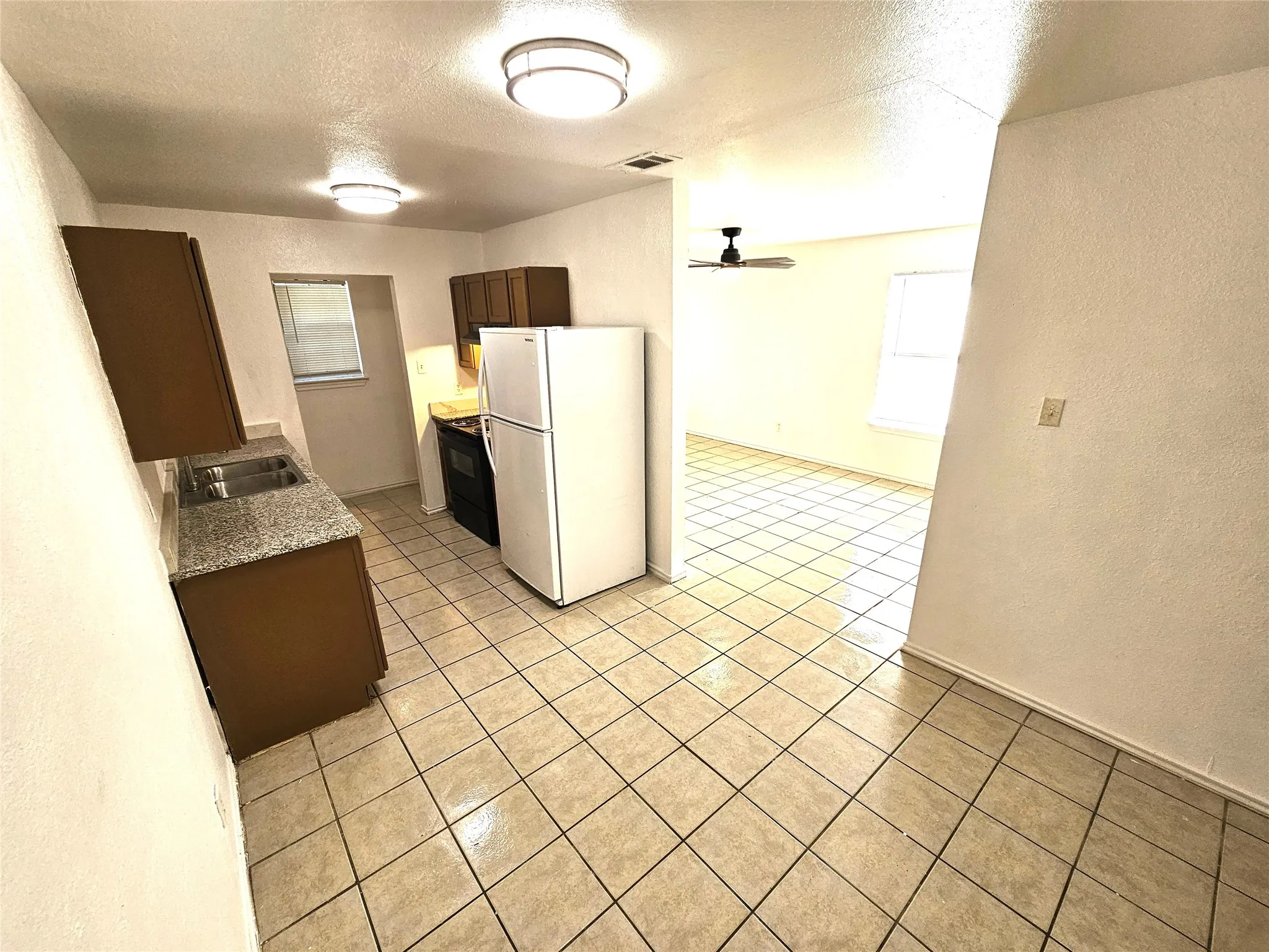 Kitchen featuring granite countertop, new sink, kitchen faucet, new modern lights