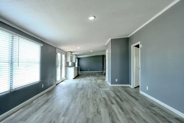 Expansive interior featuring wood-finish flooring, recessed lighting, and a neutral wall palette
