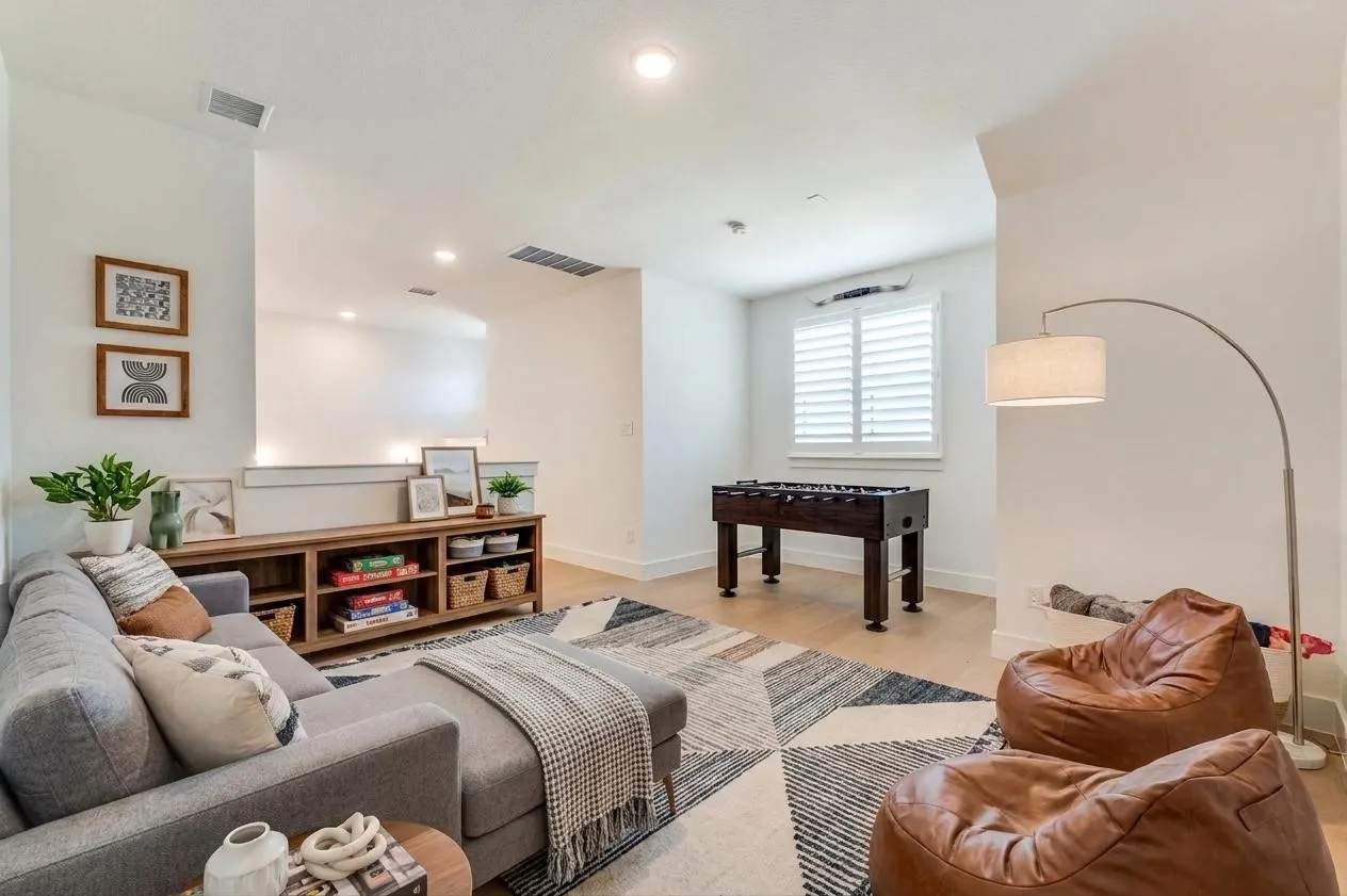 The upstairs recreation room creates the perfect space for family fun, hobbies or a second living area. Furniture, accents and accessories were Virtually Staged.