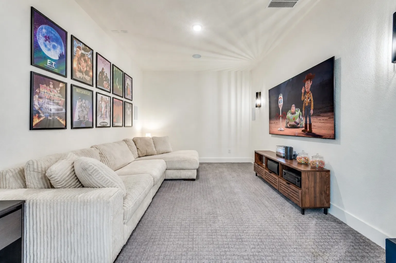 Dedicated first floor media room with sliding barn doors, six in-wall speakers and the perfect setting for movie nights or game day entertaining. Some accents were Virtually Staged.