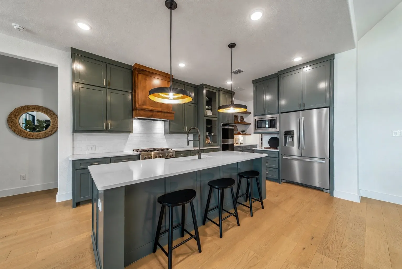 Rich painted shaker cabinetry, warm wood accents and premium finishes deliver timeless designer style. Fridge was Virtually Staged.