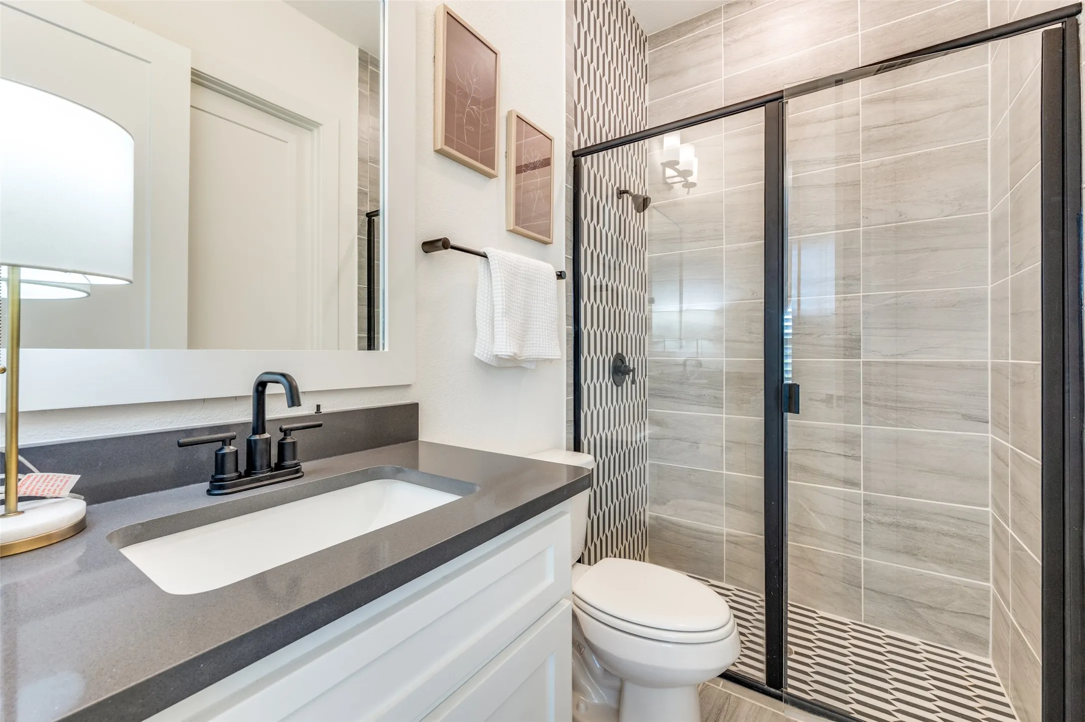 Well-appointed ensuite bath with quality finishes provides comfort and privacy for guests.