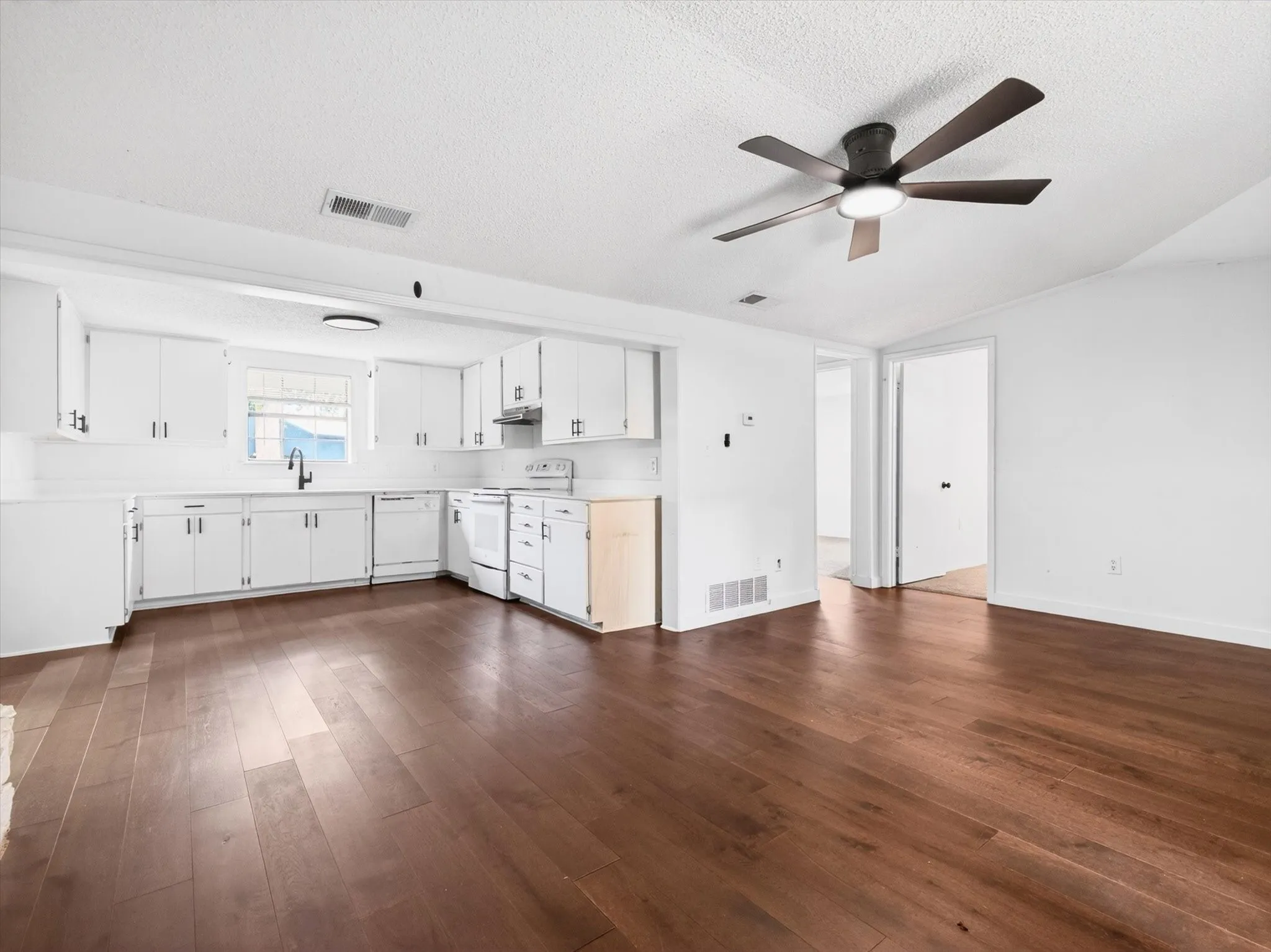 Open-concept living space featuring wood-finish flooring