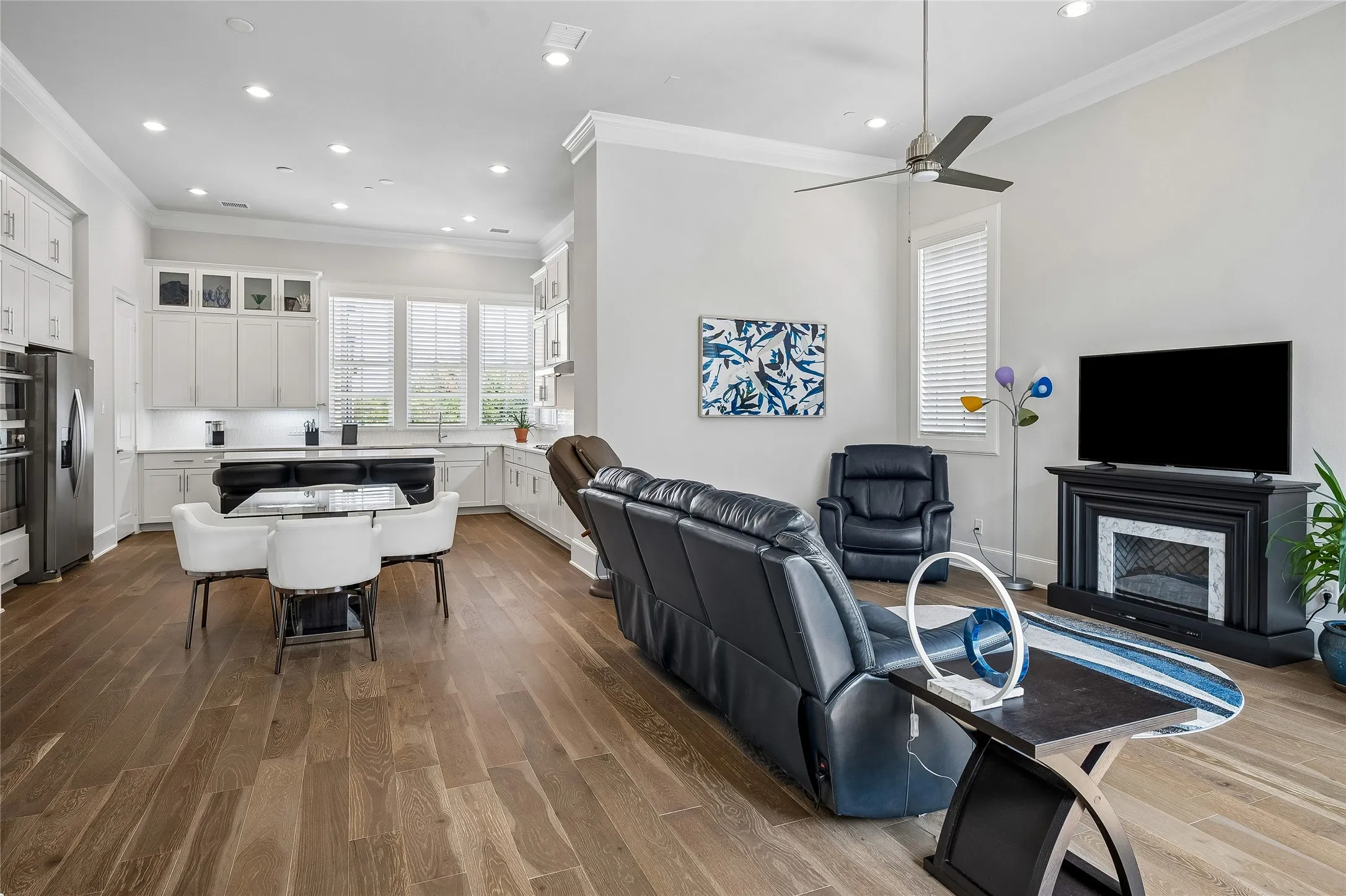 Beautiful wood floors flow seamlessly from family room to kitchen