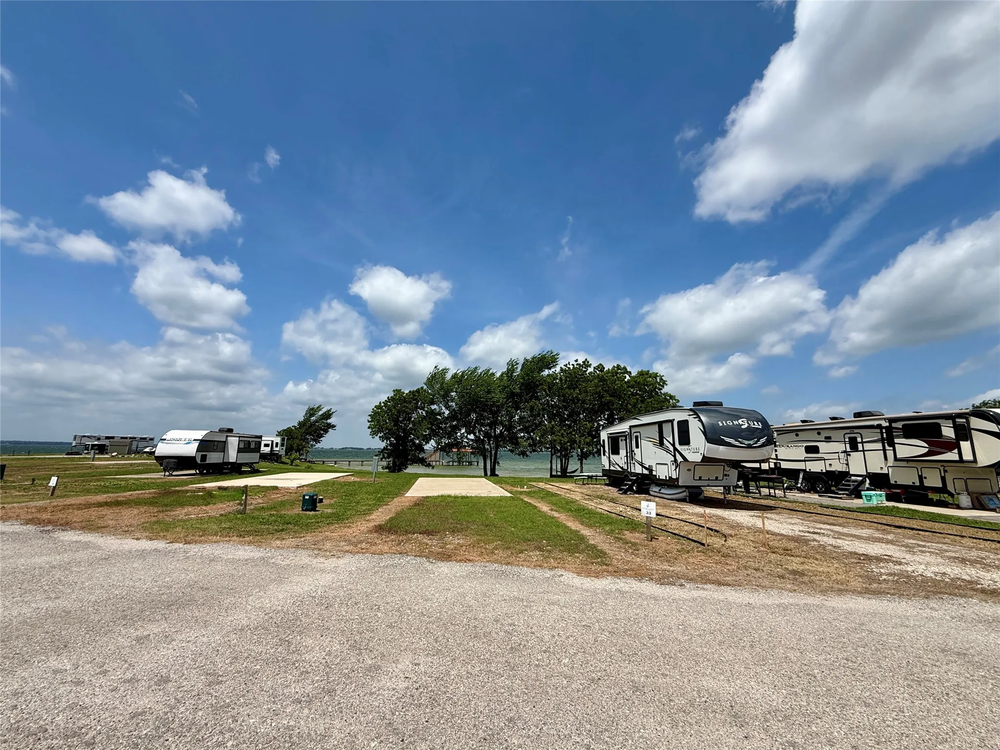 Asphalt road frontage beside the improved RV site.