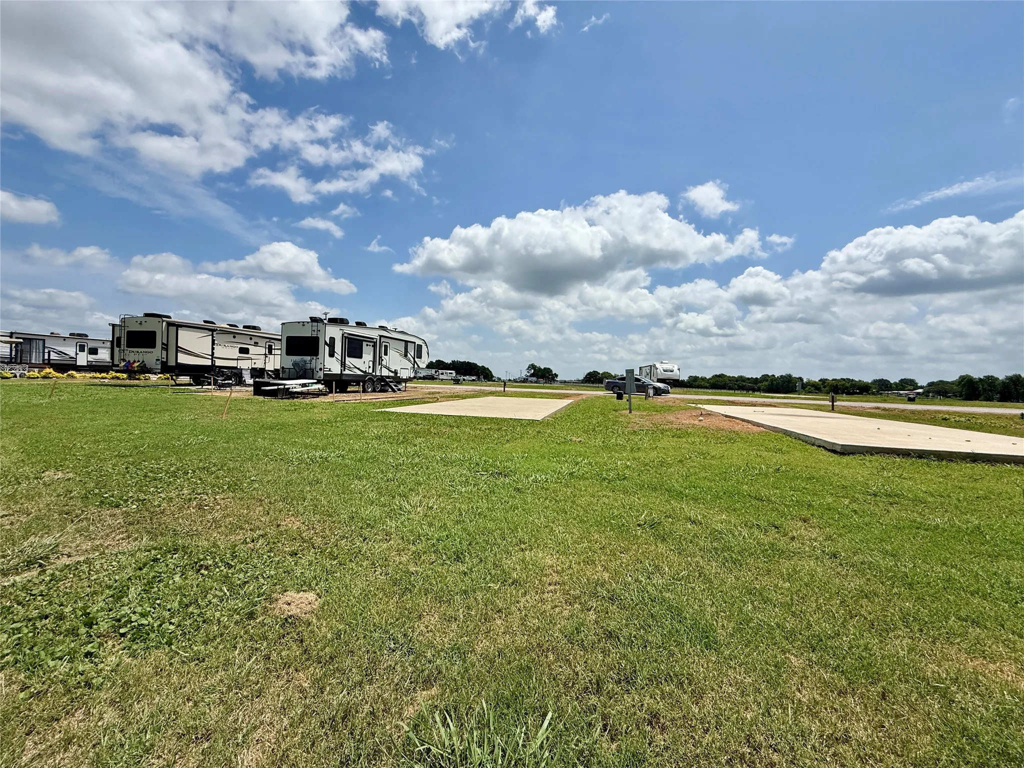 Spacious lot with RV pad and open sky views.