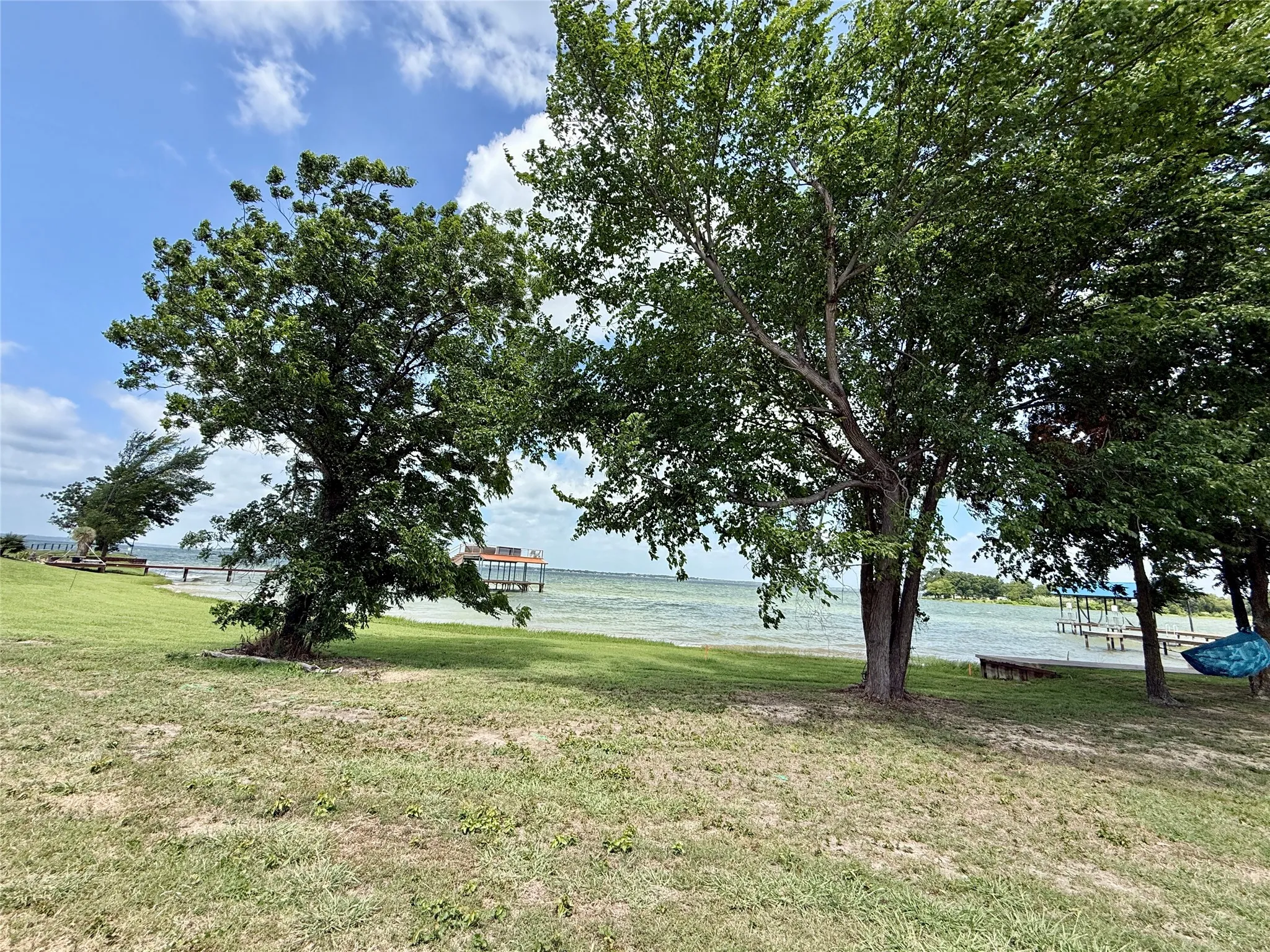 Waterfront lot with mature trees and lake access.