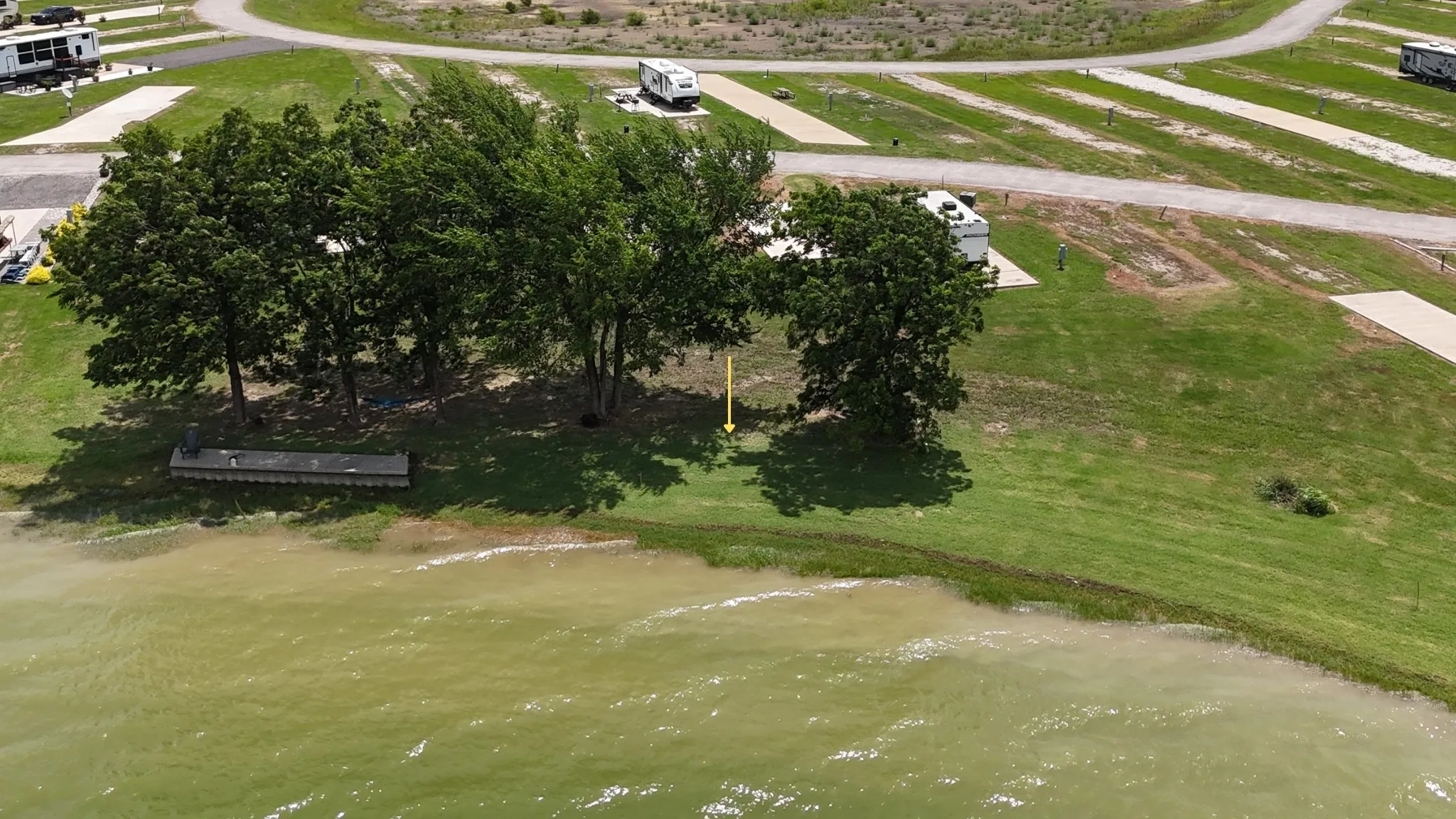 Elevated view of serene lake rv lot shoreline.