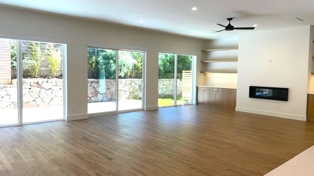 Grand room featuring beautiful hardwood floors, ceiling fan, and plenty of natural light which opens to back courtyard and side yard. Perfect for grilling!