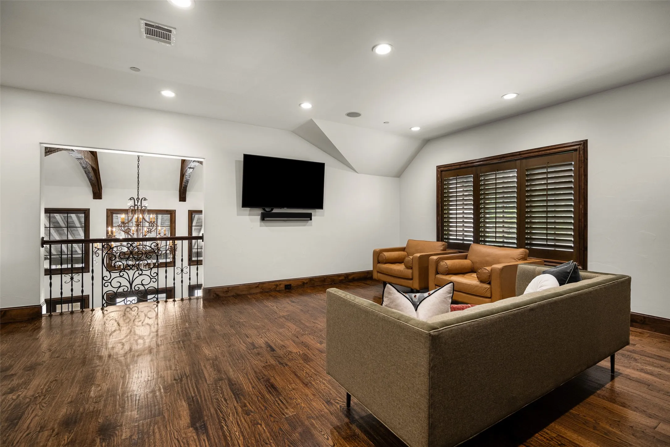 Upper level featuring wood-finish flooring, recessed lighting, and a wall-mounted media setup