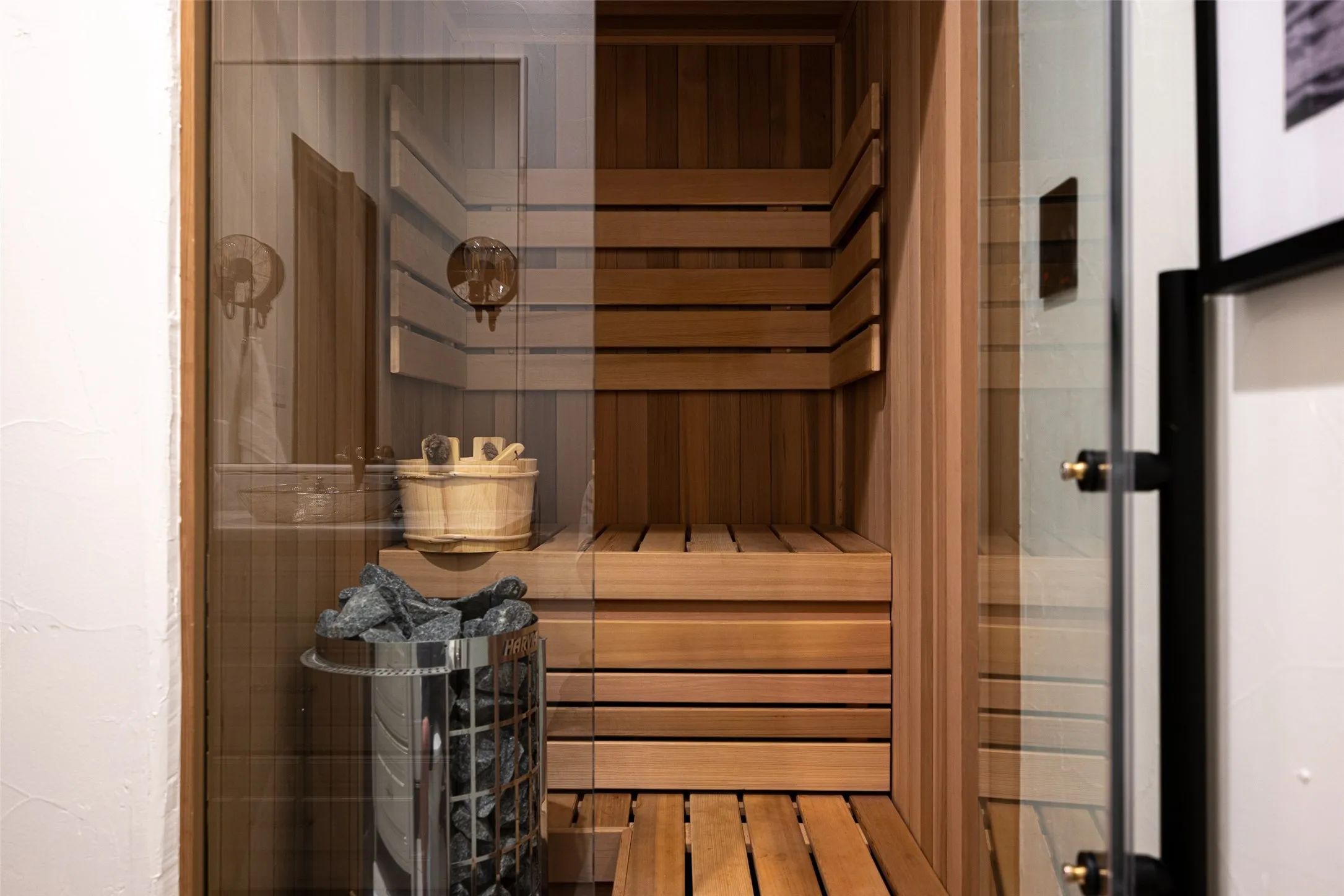 Built-in sauna featuring light wood paneling and multi-level slatted benches