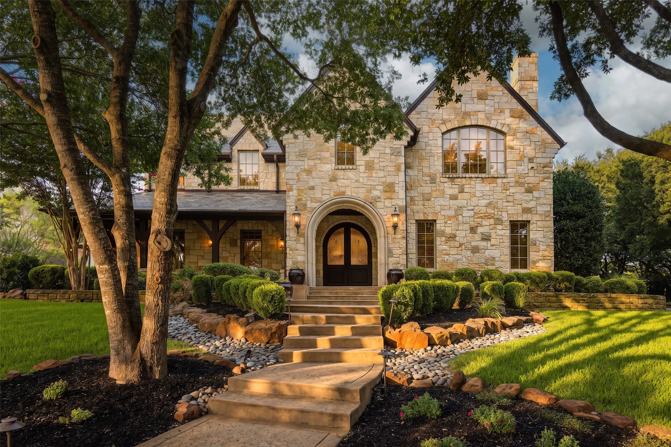 Stone exterior with arched entryway and dark wood doors