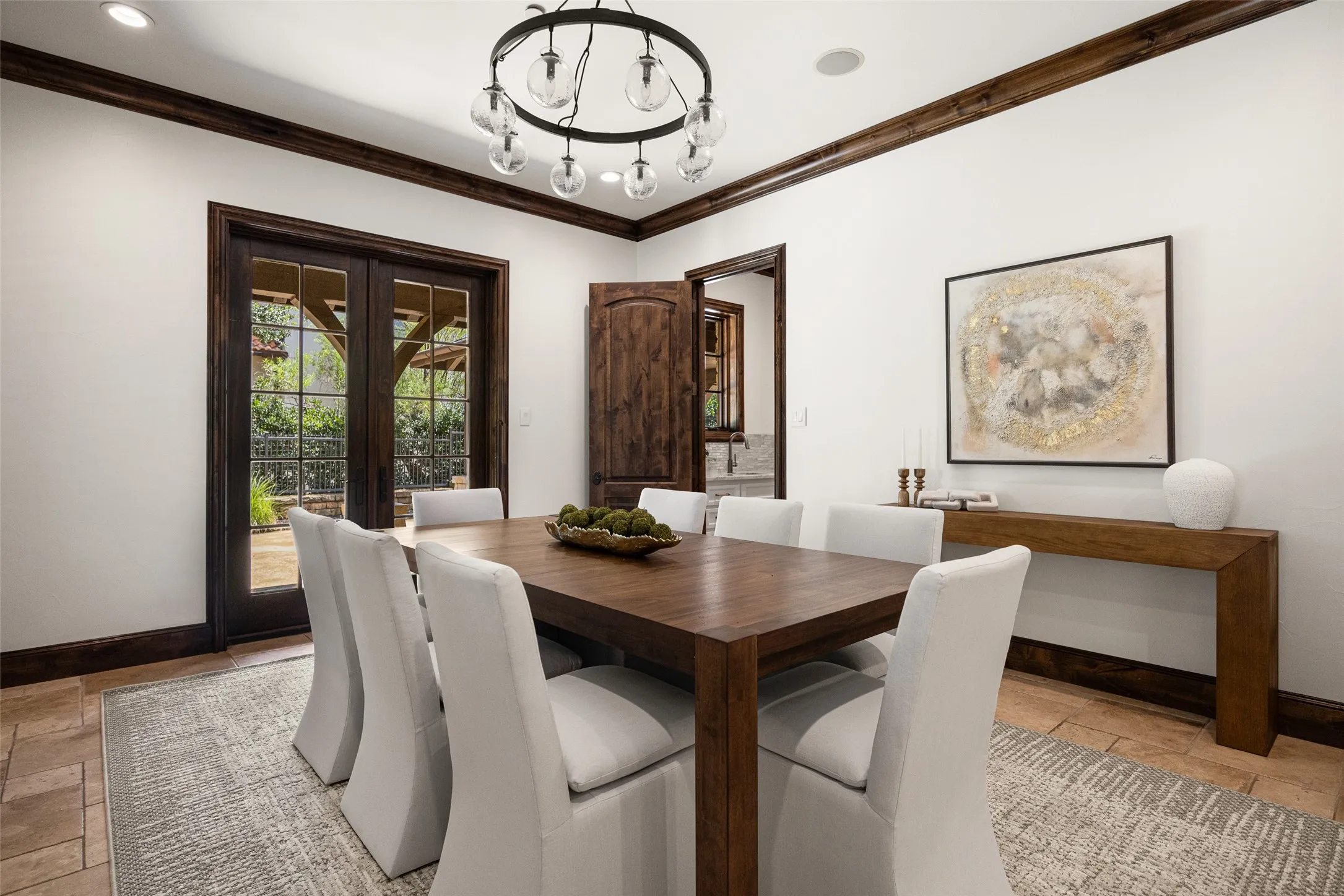 Dining space featuring rich wood-stained trim and French doors