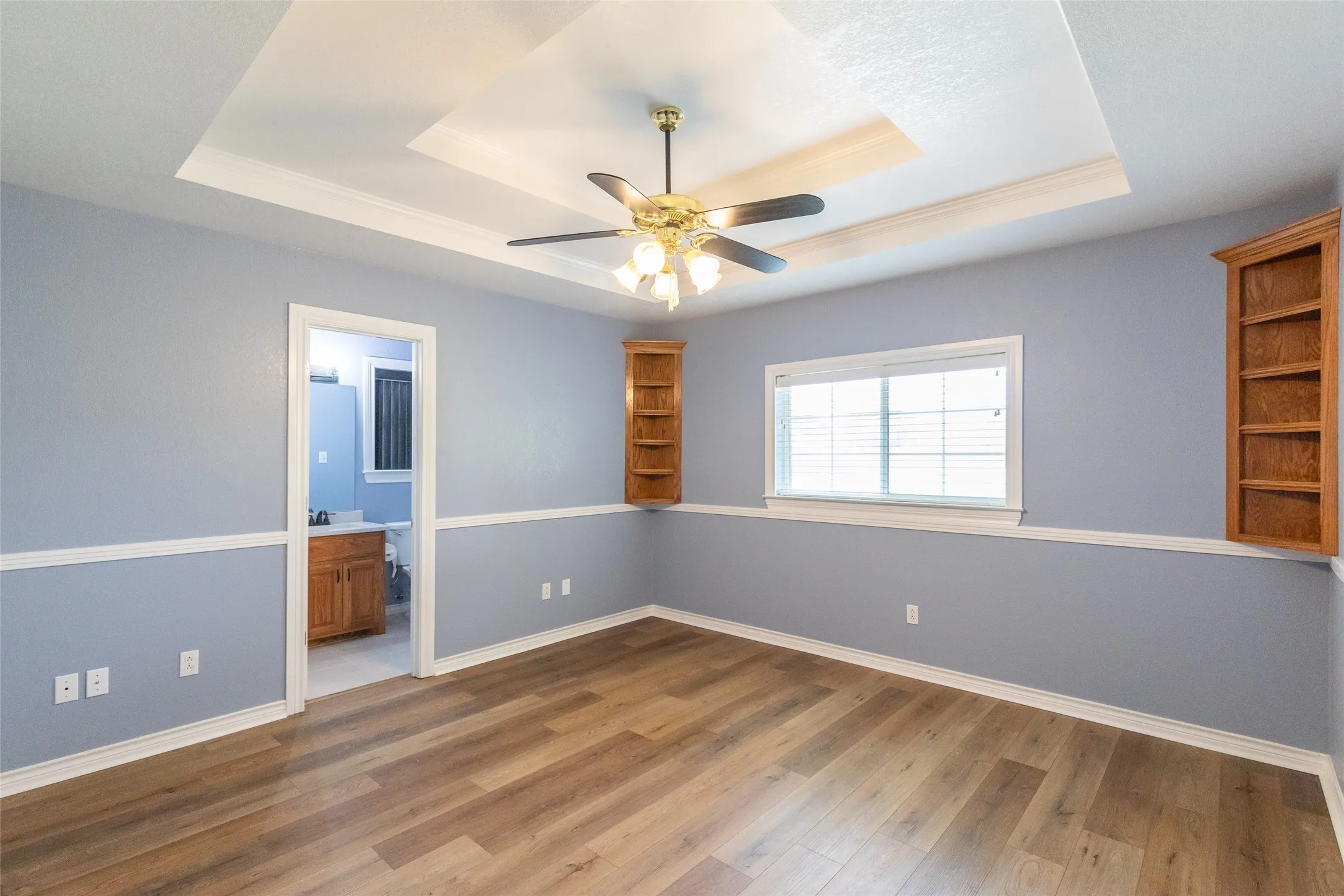 This king-sized bedroom looks out to the back yard. It features built-in oak shelves, and a private bath.