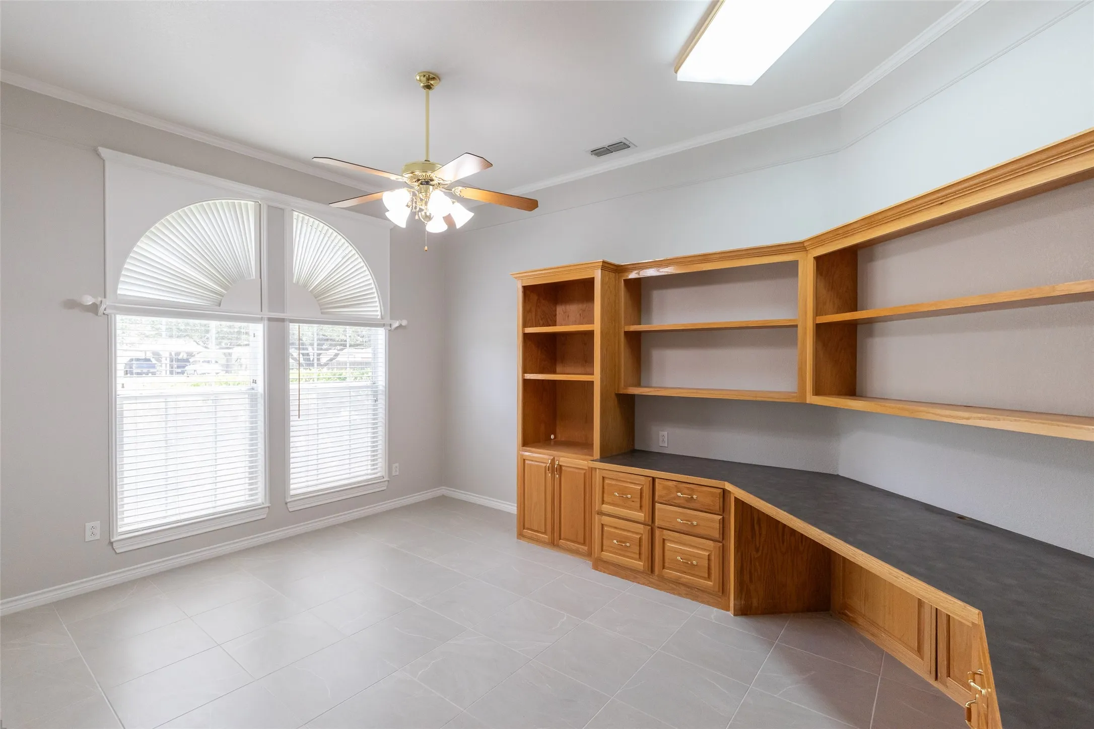 Spacious office with built in desk and storage.