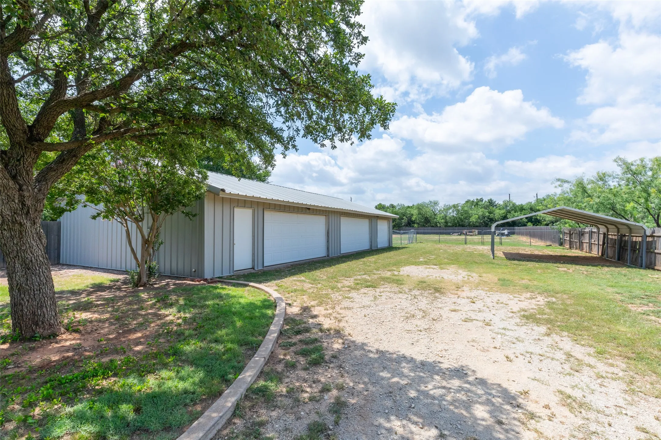 60 x 30 shop, car port and double gate access to back of acreage. Shop is accessible thru back yard as well.