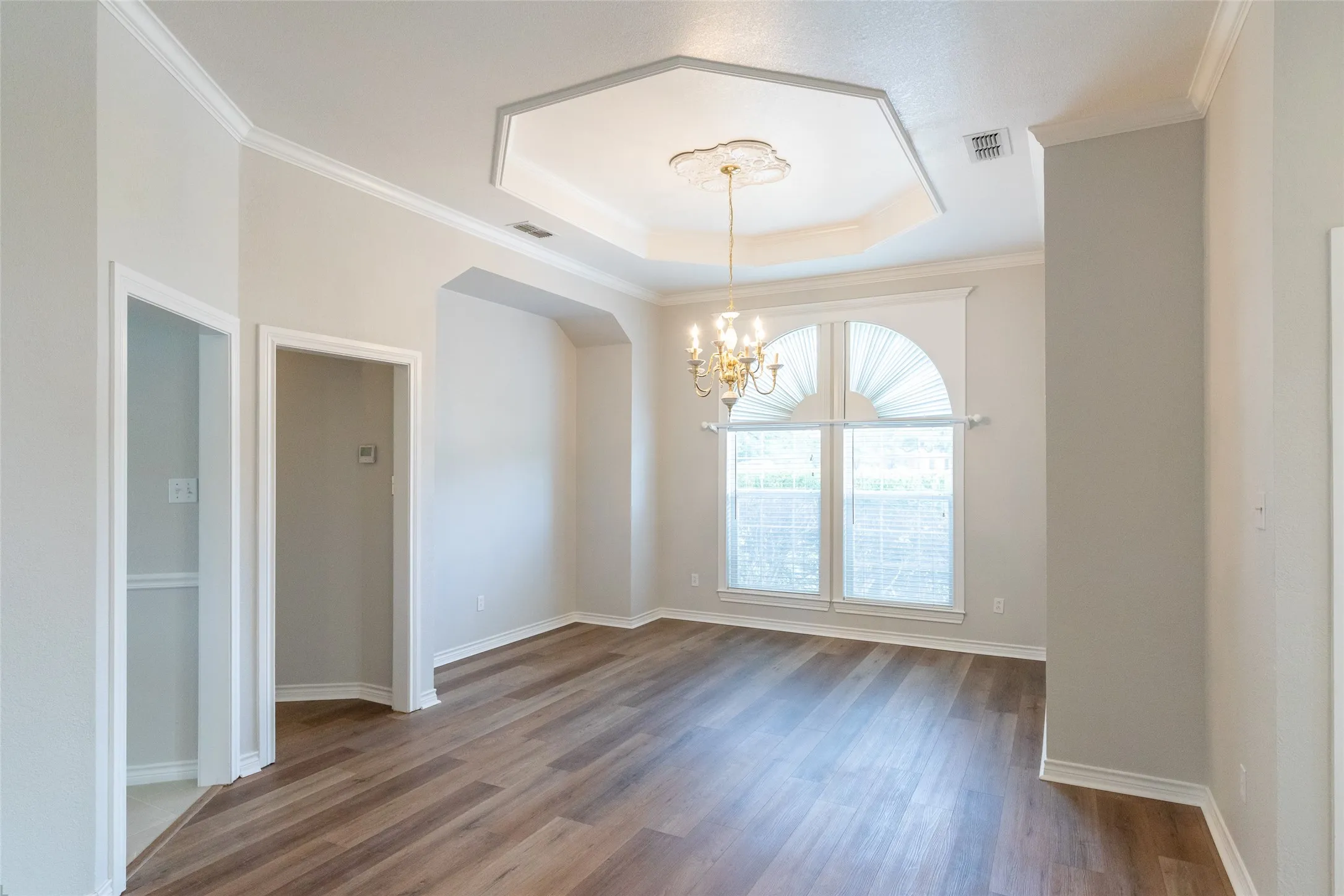Formal dining with recessed hutch and server areas allowing for table to be centered with light and windows.