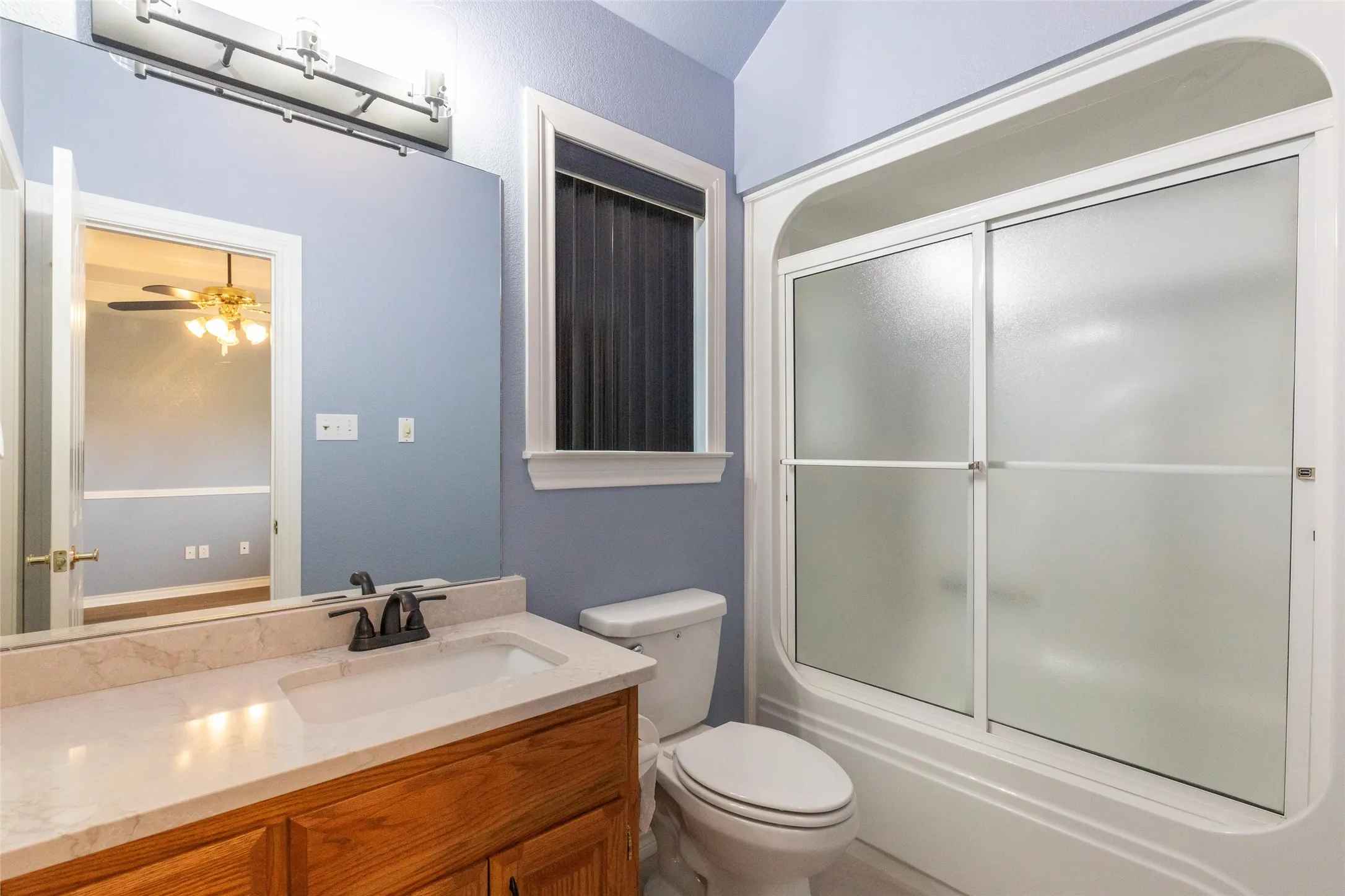 Private bath to back bedroom. To the left is the spacious closet.