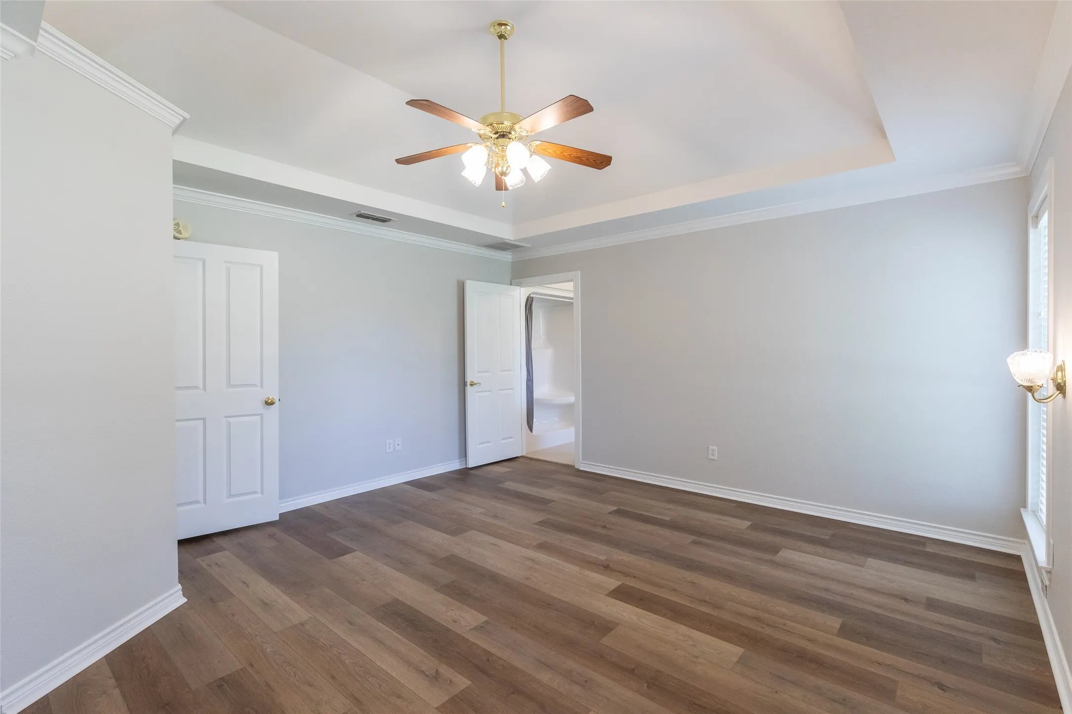 To the left is small hall leading to both the formal dining and kitchen. To the right is master bath.