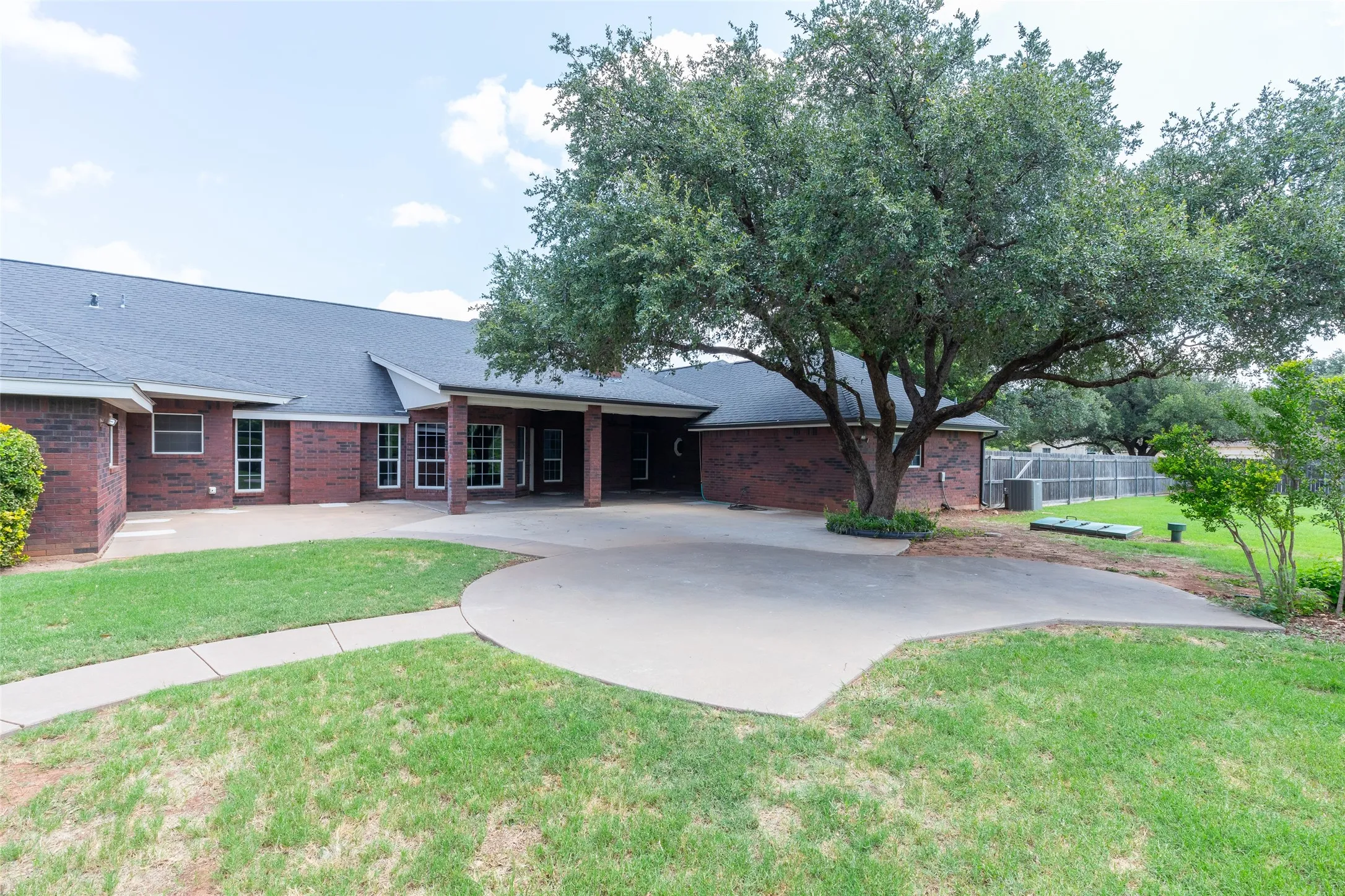 To the right, notice the in-ground storm shelter. The back patio has an entrance to the garage as well as the house.