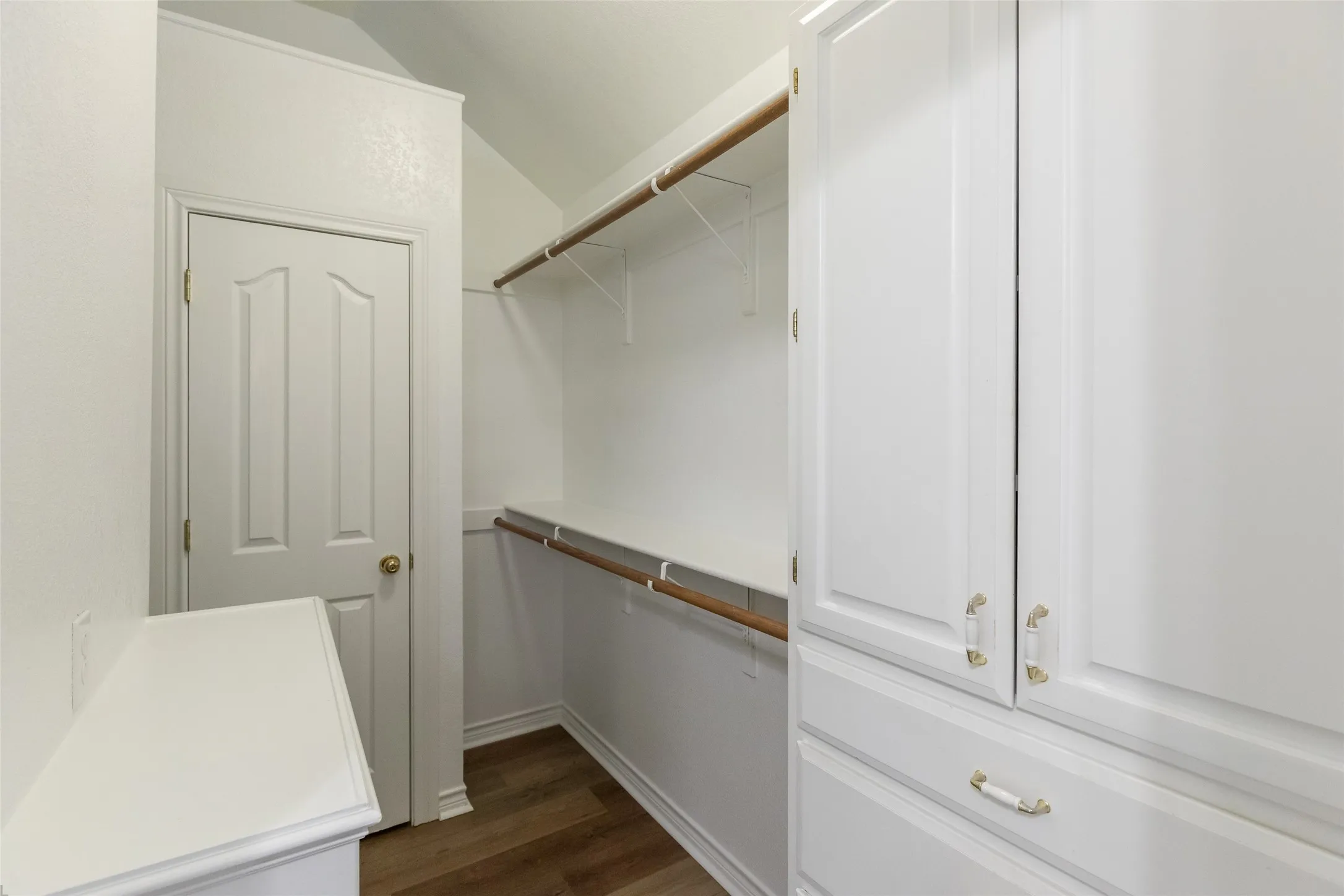 Master closet with built in dresser and shelves. Door shown is to gun closet.