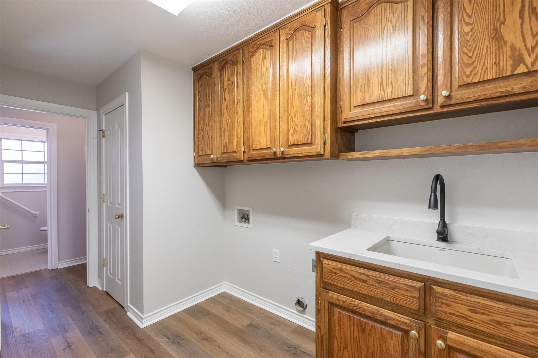 Laundry room view from the master closet. Straight through is the half bath. To the left is 2nd living, and to the right door to garage.