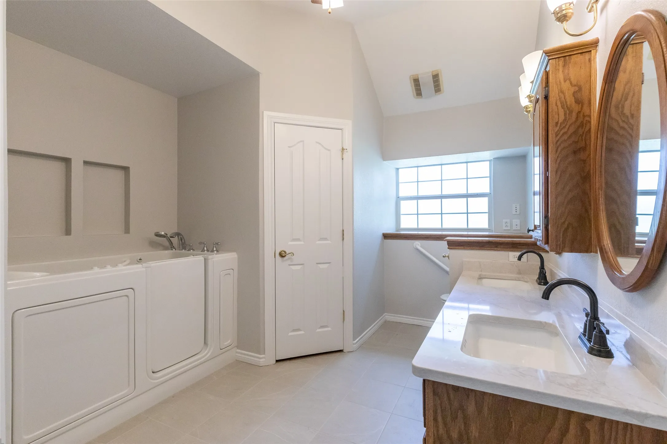 Top of the line jetted, walk in tub; double vanities; 1 of 2 doors to the master closet.