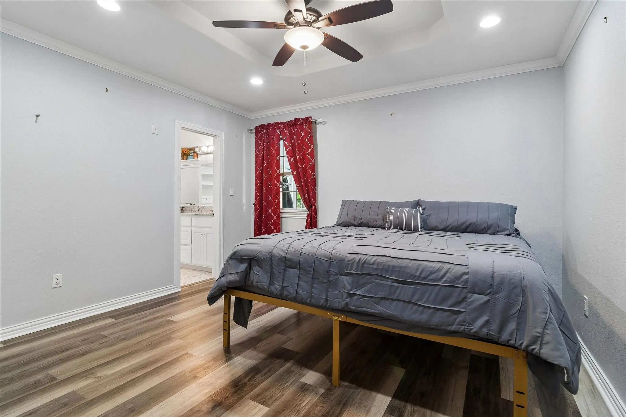 Bedroom featuring wood-finish flooring, recessed lighting, and a ceiling fan with integrated light