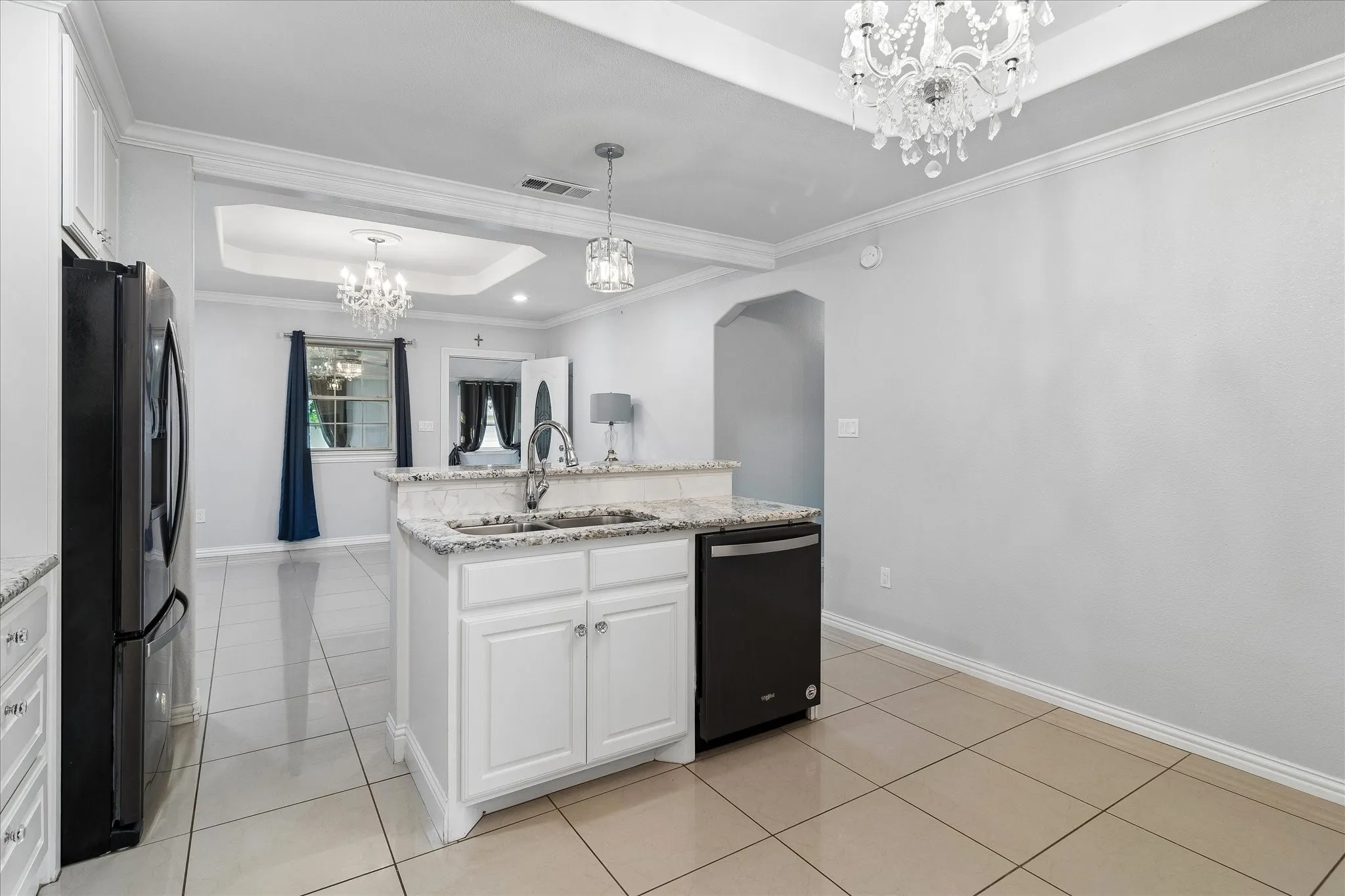 Kitchen island with granite-finish countertop, undermount sink, and integrated dishwasher