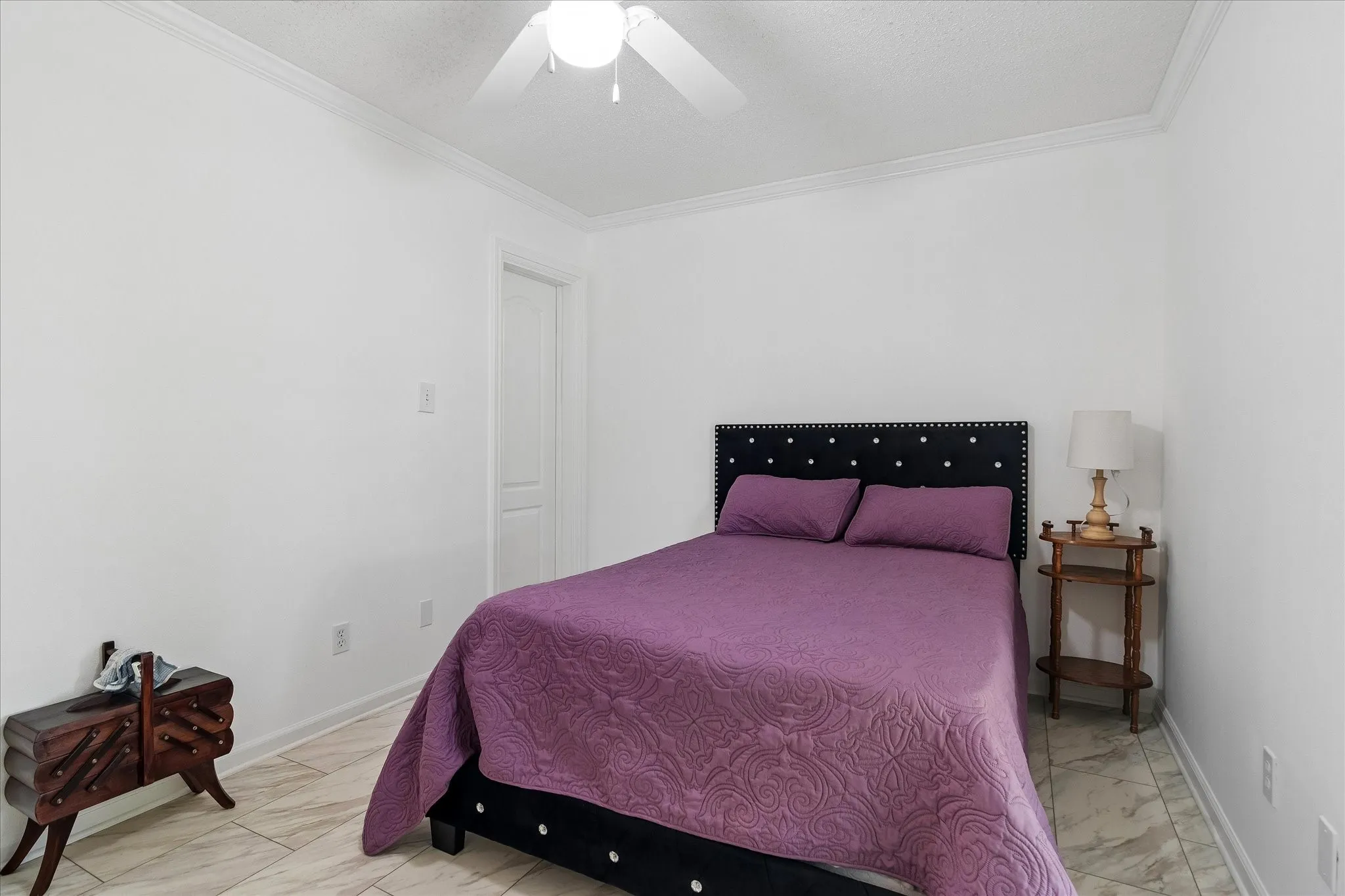 Bedroom featuring crown molding, neutral wall color, and tile flooring
